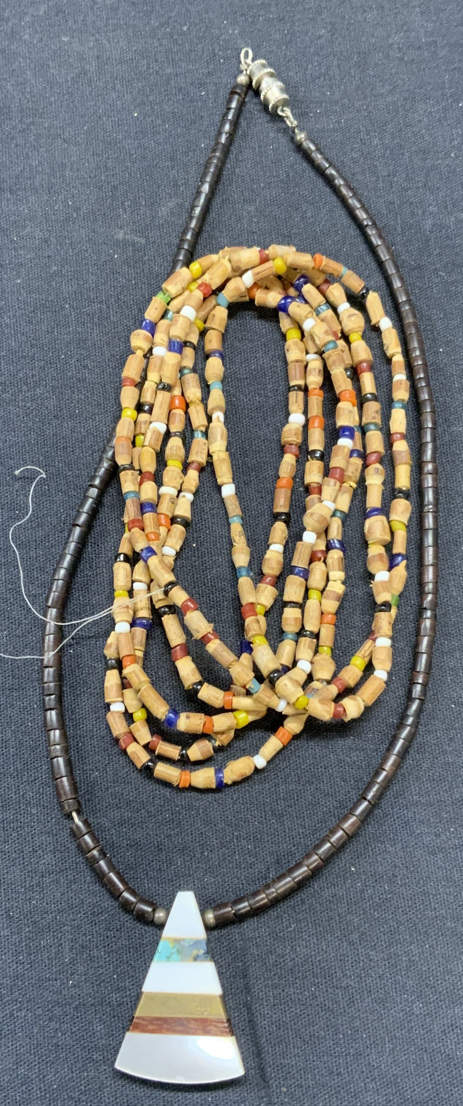 Lot 2 Mother Of Pearl Pendant Necklace, More: Lot of 2 jewelry pieces. Vintage brown chip bead necklace with inlaid mother of pearl, wood, stone, and brass pendant. Drop length approx. 7 inches. Vintage wood and seed beaded necklace. Drop length 