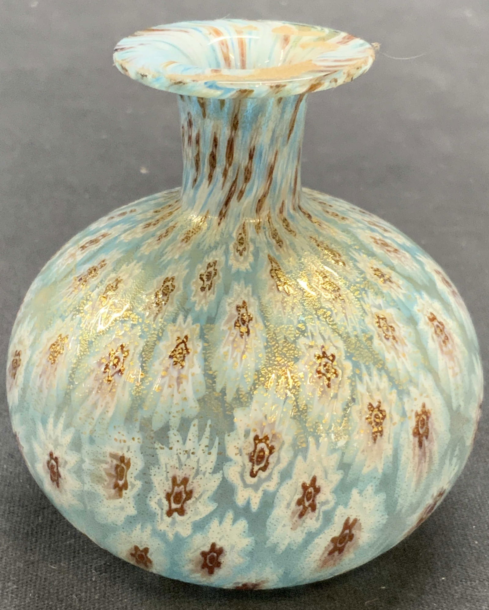 Blue Millefiori Art Glass Perfume Bottle: Hand blown millefiori Art glass perfume bottle in light blue with gold. Measures approx. 2.5 x 2.75 inches. Some surface wear including scratching observed. Art glass, art glass perfume bottle, millef