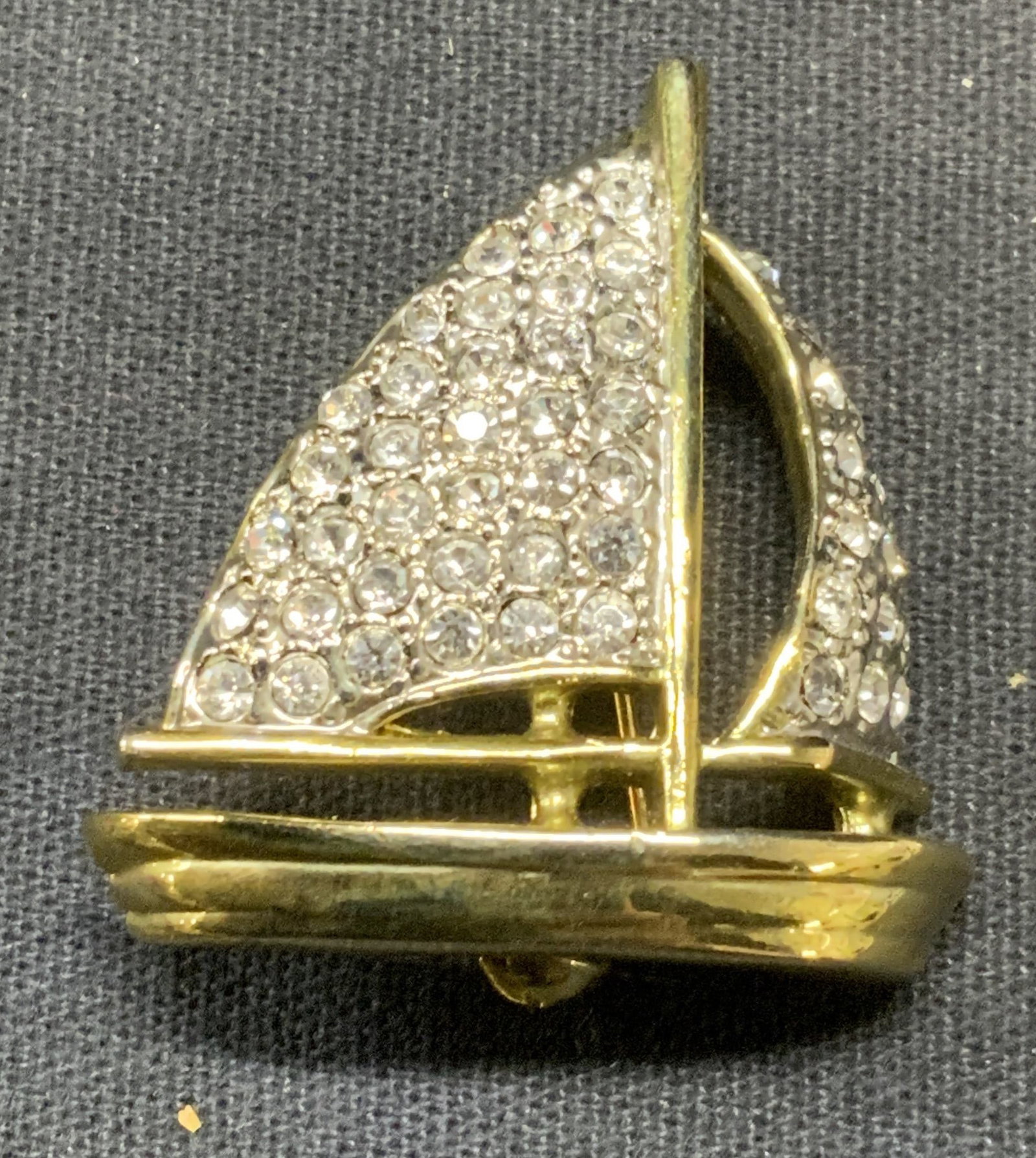 Gold Tone Crystal Sail Boat Brooch: Gold tone pave crystal decorated sail boat brooch. Hinge pin to underside. Measures approx. 1.25 x 1.25 inches. Some scratching observed. Estate jewelry, costume jewelry, cocktail jewelry, fashion jew