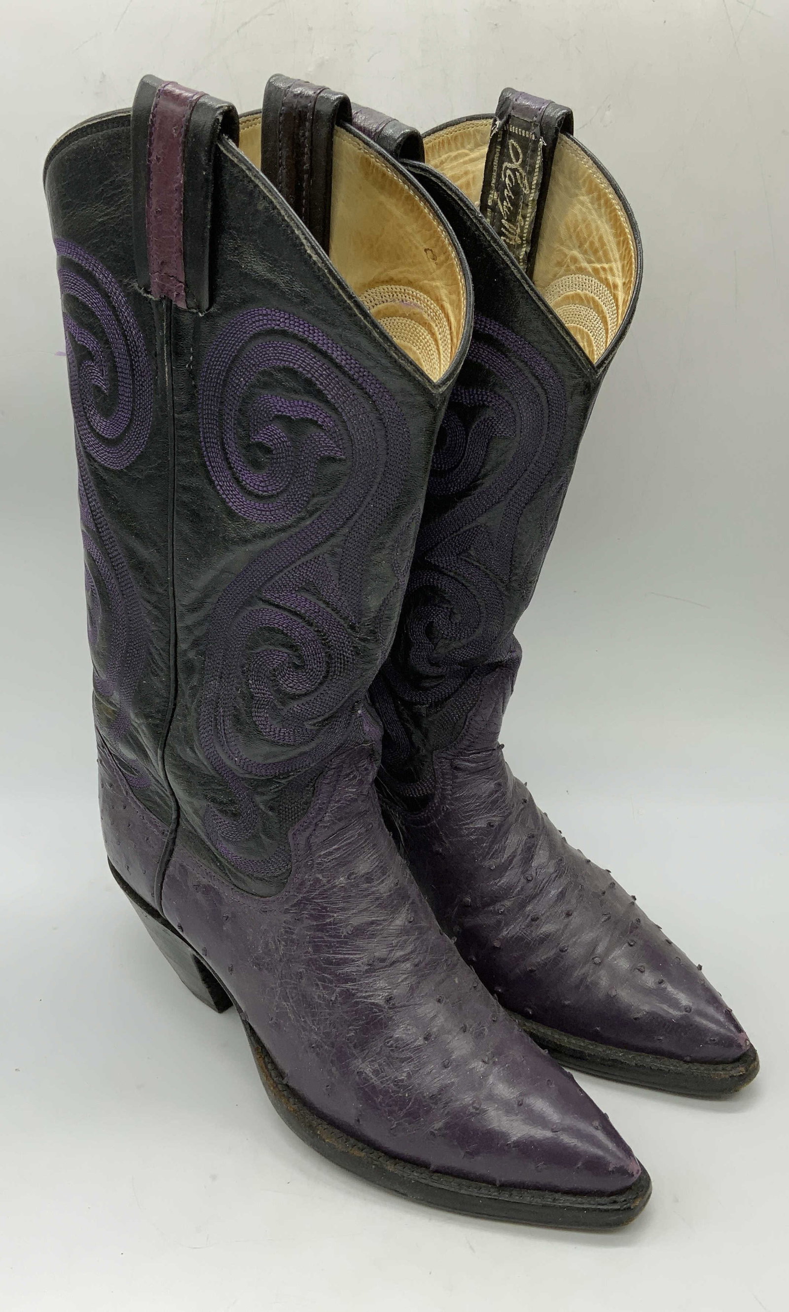 Larry Mahan Purple Ostrich Leather Boots: Larry Mahan purple ostrich leather cowboy boots. Measure approx. 9.5 inches long. Some wear to leather and soles consistent with exposure. Larry Mahan, Larry Mahan boots, ladies designer boots, ladies