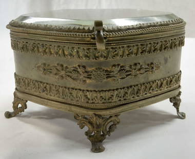 Vintage French Ormolu Footed Lidded Jewelry Box: Jewelry box is vintage. Piece is gold toned brass French ormolu with 5 ornate scrolled feet. Jewelry box has beveled glass lid. Piece measures approximately 5.5 inches wide 4.5 inches deep 3.25 inches