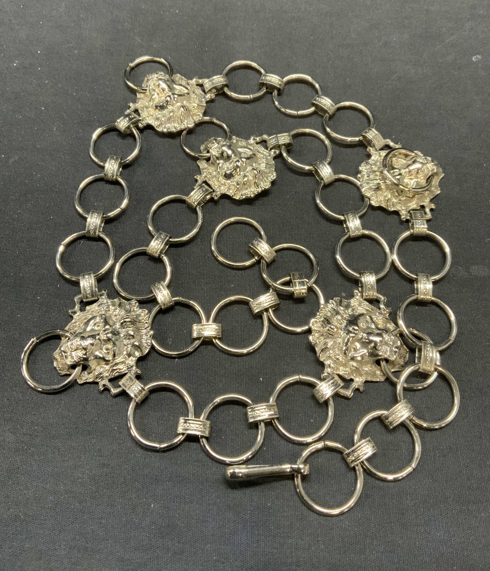 Silver Tone Sculptural Lion Chain Link Belt: Silver tone chain link belt with sculptural lion head panels. Measures approx. 36.5 inches long. Some scratching observed. Ladies belt, ladies chain belt, ladies silver tone belt, ladies lion belt, la