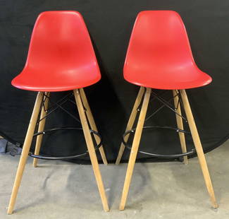 Pr MCM Bar Stools Red: Bar stools are mid century modern. Each have red toned bucket seats, splayed wooden legs with circular shaped black toned stretchers in between. Stools each measure approximately 42 inches tall 21.5 i