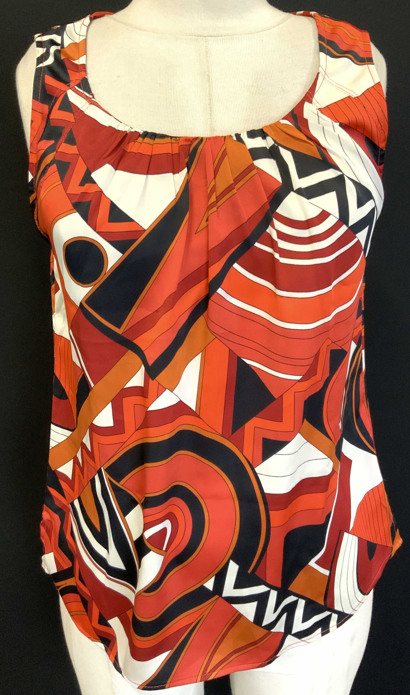 Chicos Sleeveless U Neck Blouse NWT: Chicos new with tag, sleeveless U neck blouse with orange and black and white geometric patterns. Size 0 Torso measures 22.5 inches and chest measures 18 inches across Minor pulling to threading due t