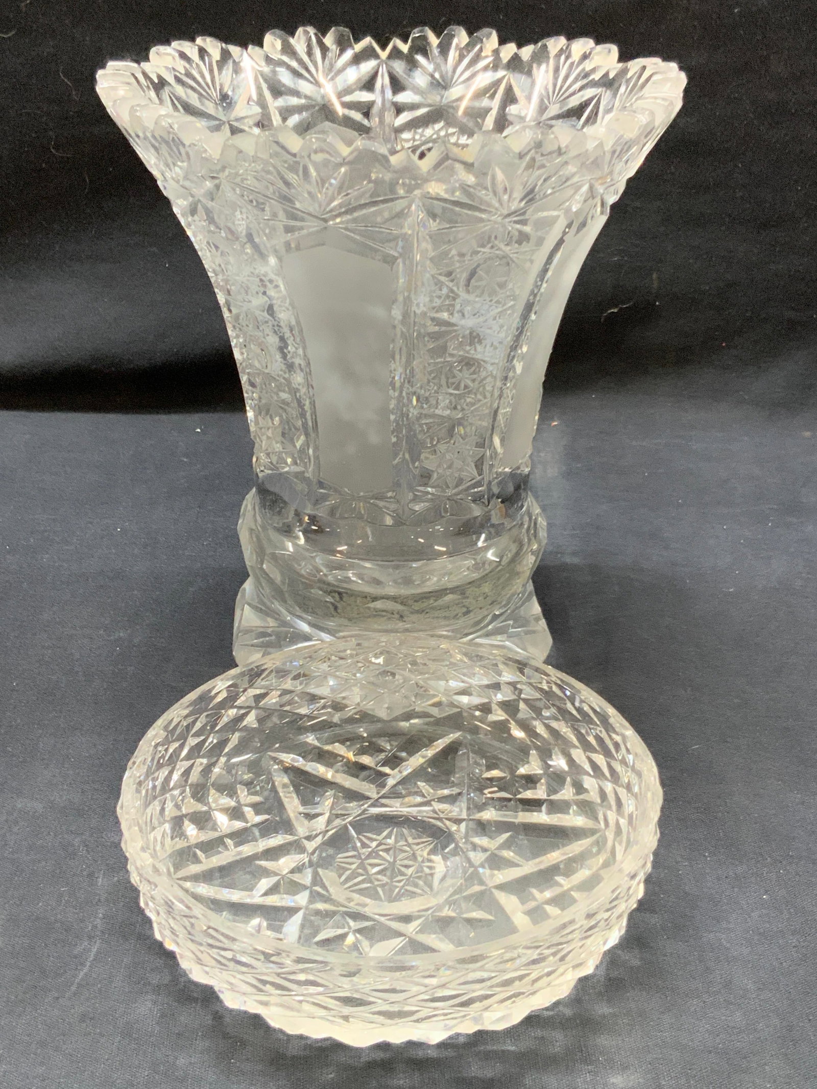 2 Cut Glass & Waterford Crystal Vessels: Lot of 2 cut glass and crystal vessels. 1 cut glass vase with saw tooth edges and flared rim with Star burst patterns cut into exterior, approx 6.5 inches tall and 6 inch diameter and 1 Waterford cut 