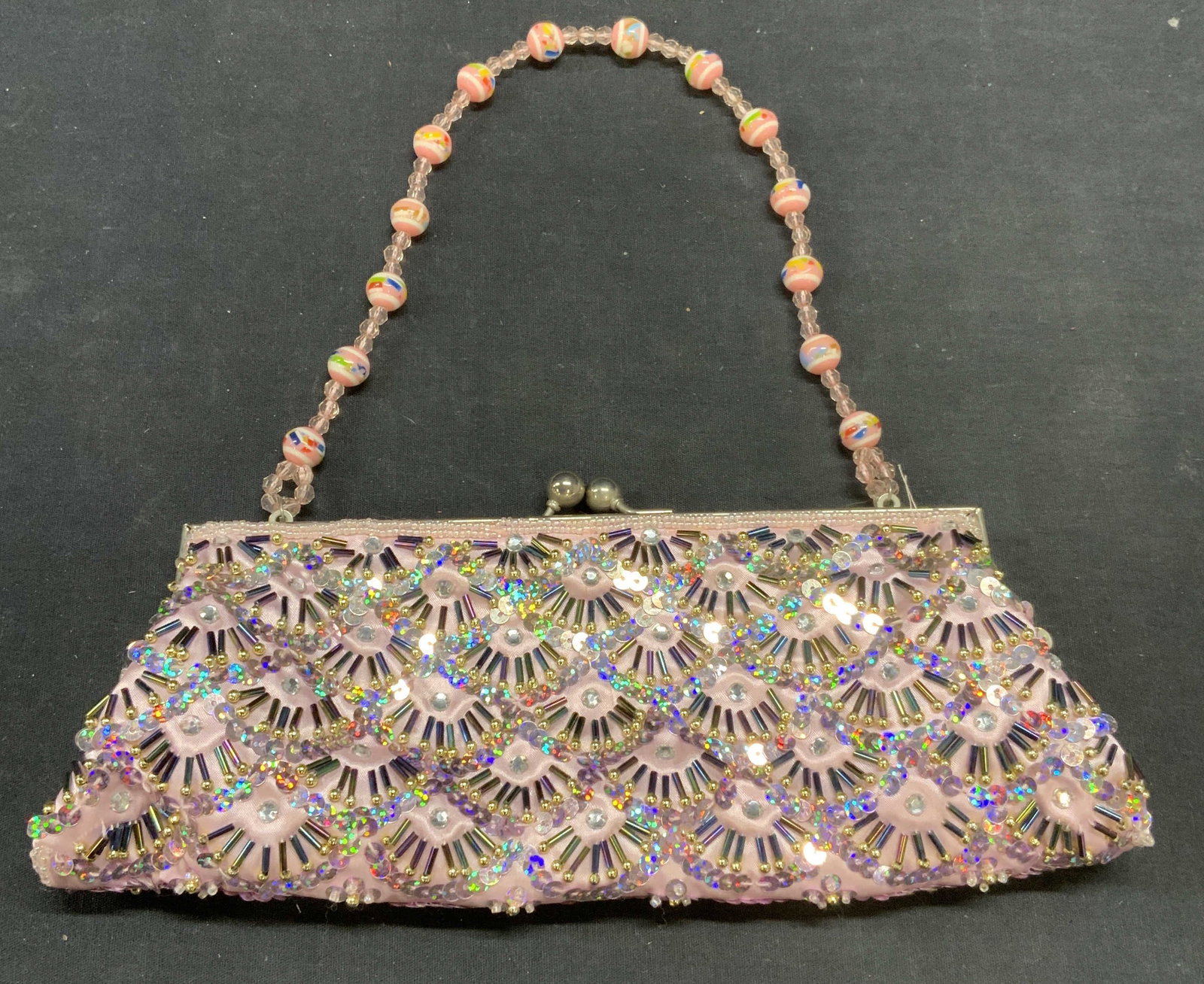 Vintage Beaded Pink Satin Handbag: Vintage beaded pink satin handbag. Beaded lucite strap. Measures approx. 10.5 x 1.5 x 4 inches. Some wear to material including loss to beading and blemishes observed. Ladies handbag, ladies pink hand