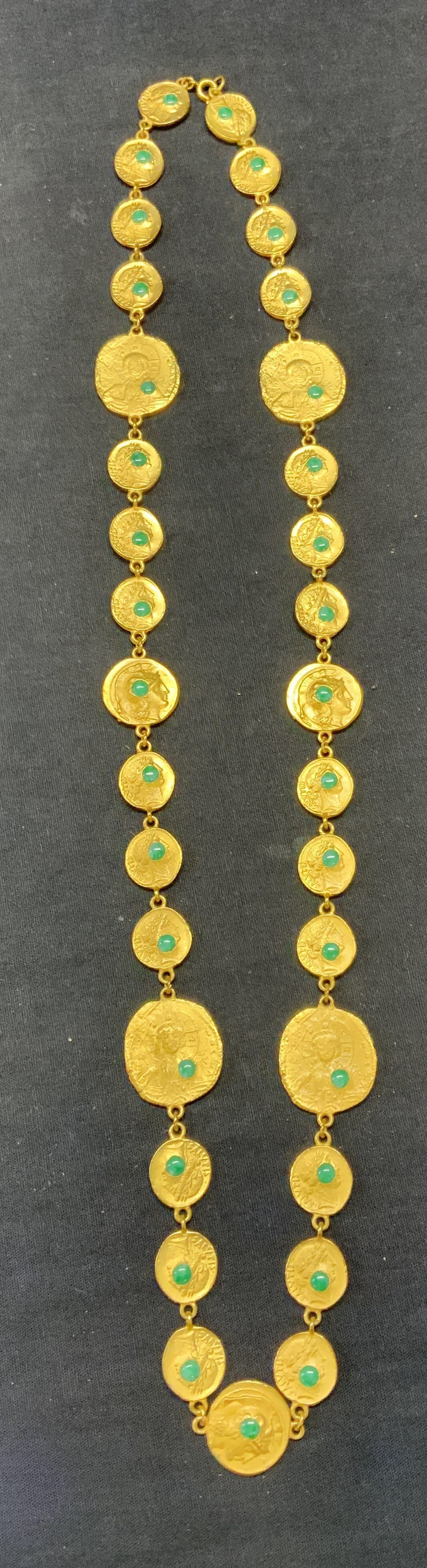 Vintage Gold Tone Coin Chain Necklace: Vintage gold tone embossed coin motif with green toned cabochons. Drop length approx. 15.5 inches. Some scratching observed. Estate jewelry, costume jewelry, cocktail jewelry, fashion jewelry, accesso