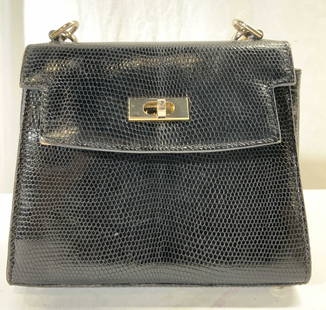 SAKS FIFTH AVENUE Reptile Skin Purse ITALY: Interior has plaque which reads SAKS FIFTH AVENUE MADE IN ITALY. Purse is black toned reptile skin. Piece has gilt metal hardware with twist clasp. Interior has 1 zipper pocket. Purse measures approx