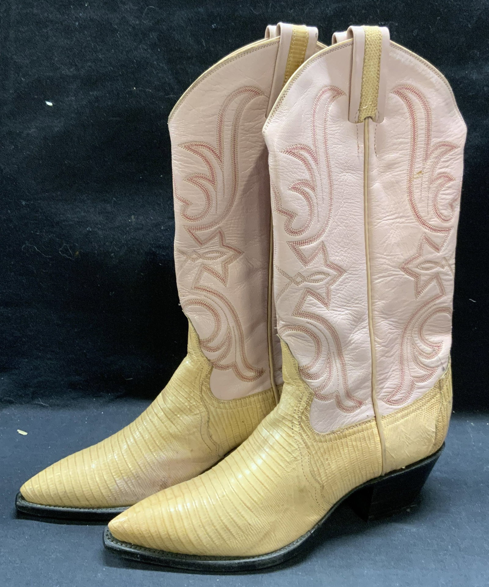 Larry Mahan Pink Reptile Leather Western Boots: Larry Mahan Pink and tan reptile leather western boots with embroidered design. Measures approx. 9.5 inches long/approx. size 6.5. Some wear to leather and soles consistent with exposure. Property of 