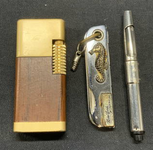 Lot 3 Firebird Lighter, NY Aquarium Fob +: Lot of 3 pieces. Vintage gold tone and wood Firebird lighter. Not tested. Measures approx. 2.5 x .5 x 1 inches. Vintage silver tone New York Aquarium nail file, bottle opener, and knife accessory keyc