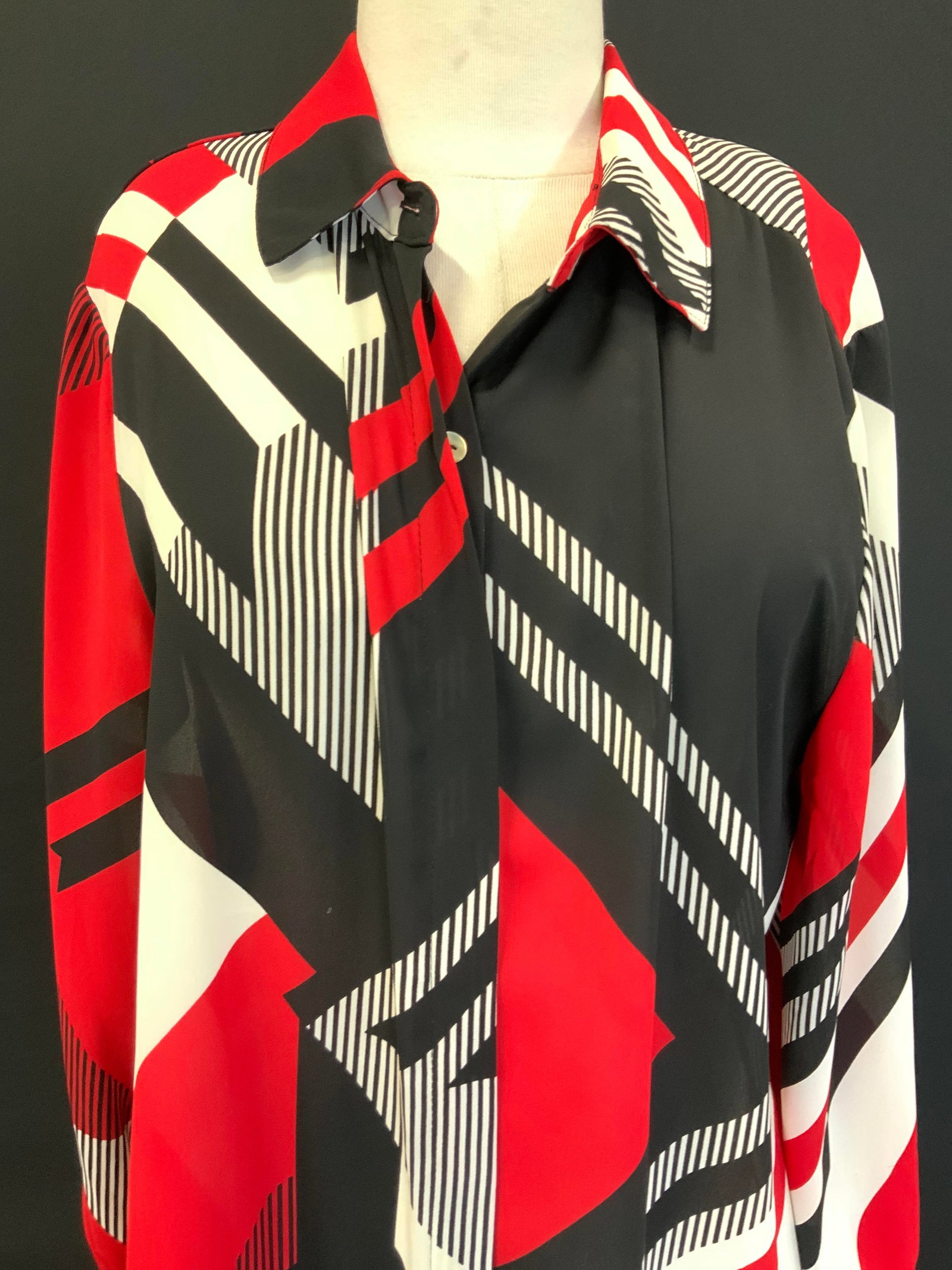Dennis Basso Geometric Button Up: Dennis Basso Geometric black red and white collard button up shirt, size 12, 100% Polyester. With mother of Pearl buttons Sleeves measure 15 inches from underarm inseam, torso measures 29 inches and c