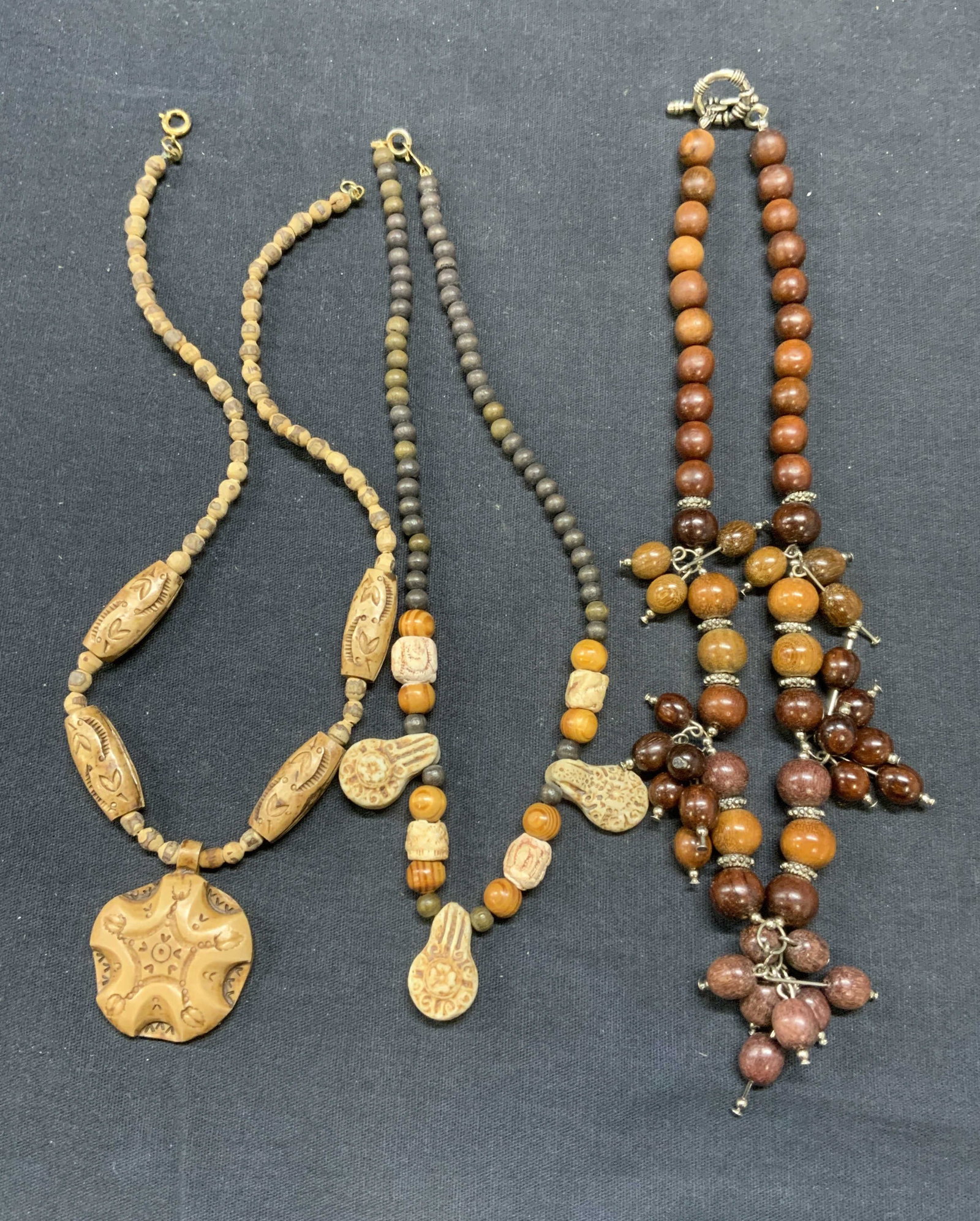 Lot 3 Wood Beaded Necklaces: Lot of 3 wood and composite beaded necklace. Sizes vary slightly, drop length approx. 7.5 inches each. All necklace have some surface wear including scratching observed. Estate jewelry, costume jewelr