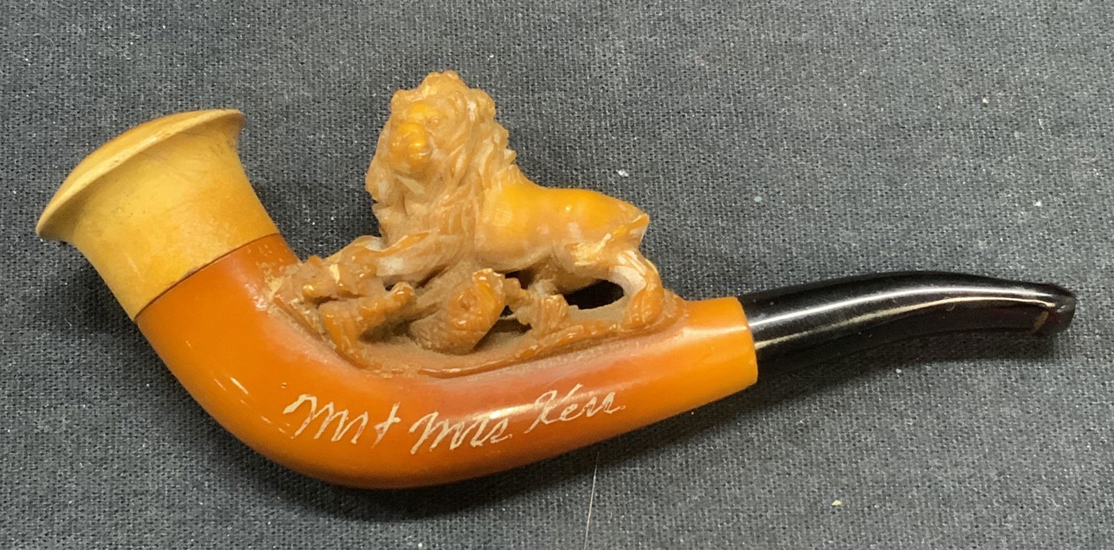 Vintage Carved Meerschaum Lion Figural Pipe: Vintage carved pipe with lion motif. Etched Mr & Mrs Ken on pipe. Appears to be carved meerschaum. Bakelite stem. Some chipping and scratching observed, measures approx. 4.25 inches long, 1.5 inches h