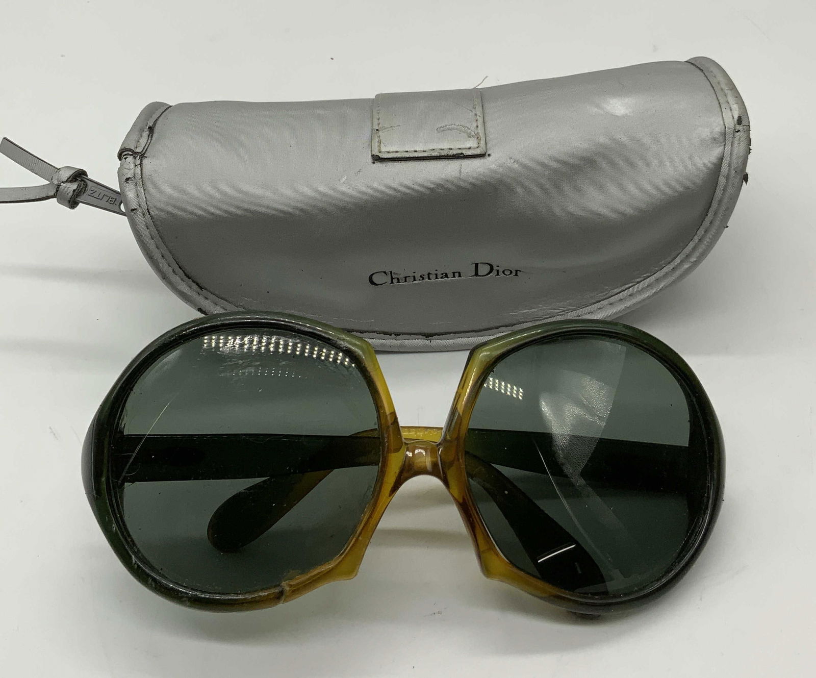 Vintage Christian Dior Green Frame Sunglasses: Vintage Christian Dior green toned acrylic frame sunglasses with case. Signed on arm. Measure approx. 5.75 inches wide, arm approx. 5 inches long. Surface wear including scratching, marks, and repairs