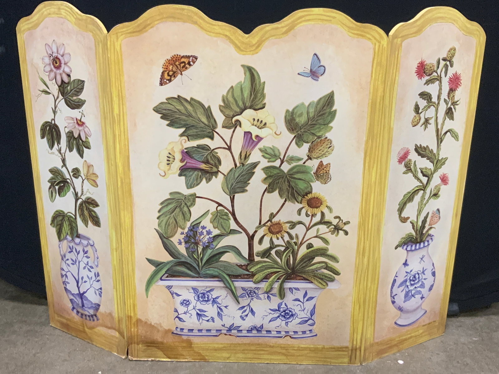 Susan Welsh, 1996 Wooden Floral Fireplace Screen: Marked on lower right panel, Susan Welsh, 1996. Backside of panel reads STUPELL industries. Made in America. Triple panel wooden fireplace screen with painted still lives of vibrant flowers in Chinese