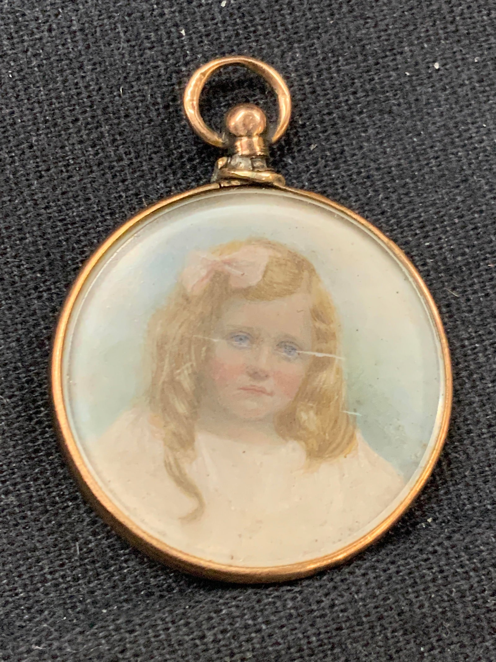 Antique Hand Painted Portrait In 375 Gold Locket: Antique hand panted portrait of a young girl with blonde curled hair in a white dress. Painted possibly on porcelain or bone, not examined outside of locket. Painting rests within a 375 stamped gold F