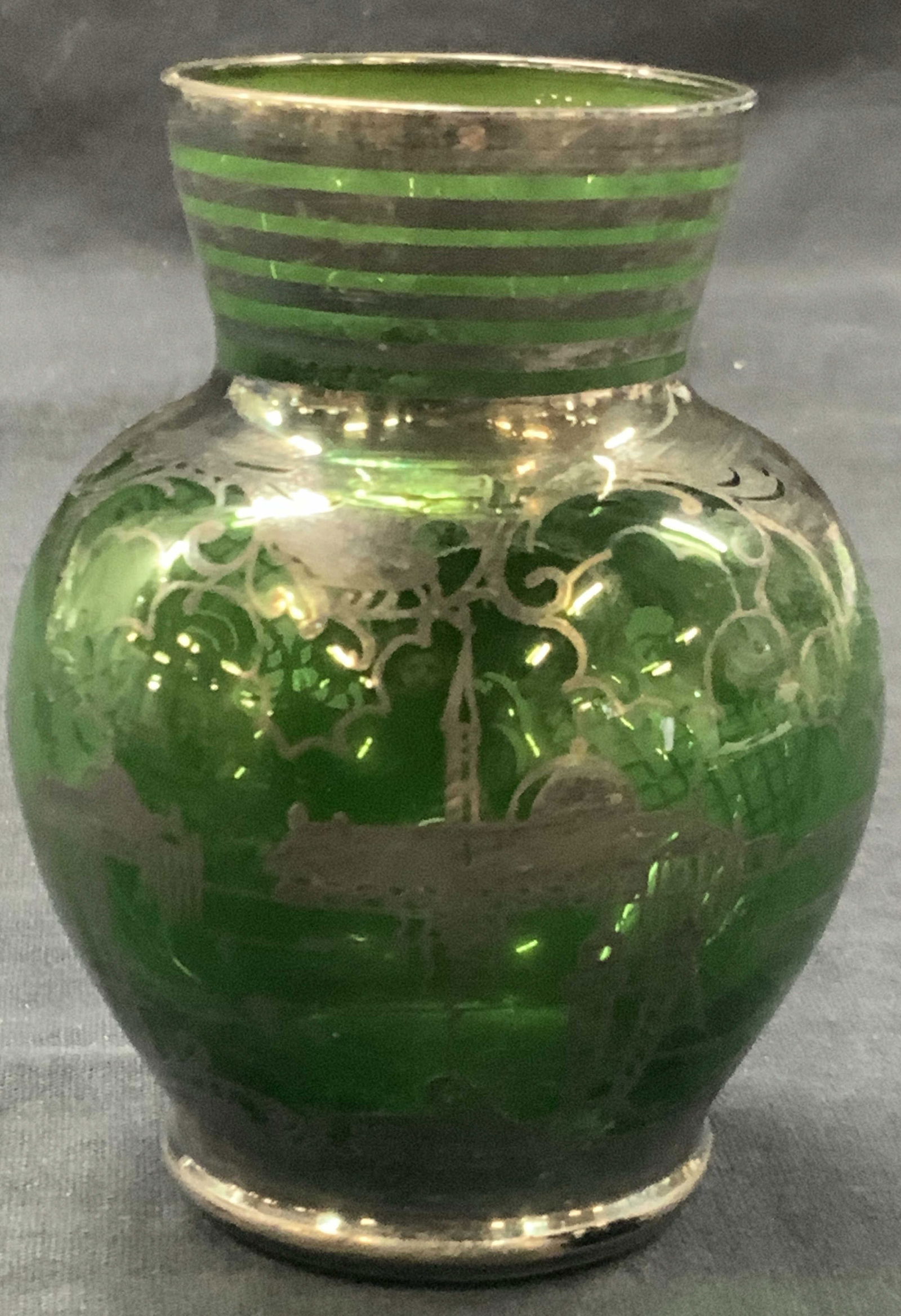 Vtg Emerald Green Sterling Silver Overlay Vessel: Vintage emerald green toned glass vessel with silver overlay creating silhouette images of Italian monuments and scroll designs with checkered patterns. Approx 4 inches tall. Moderate discoloration to