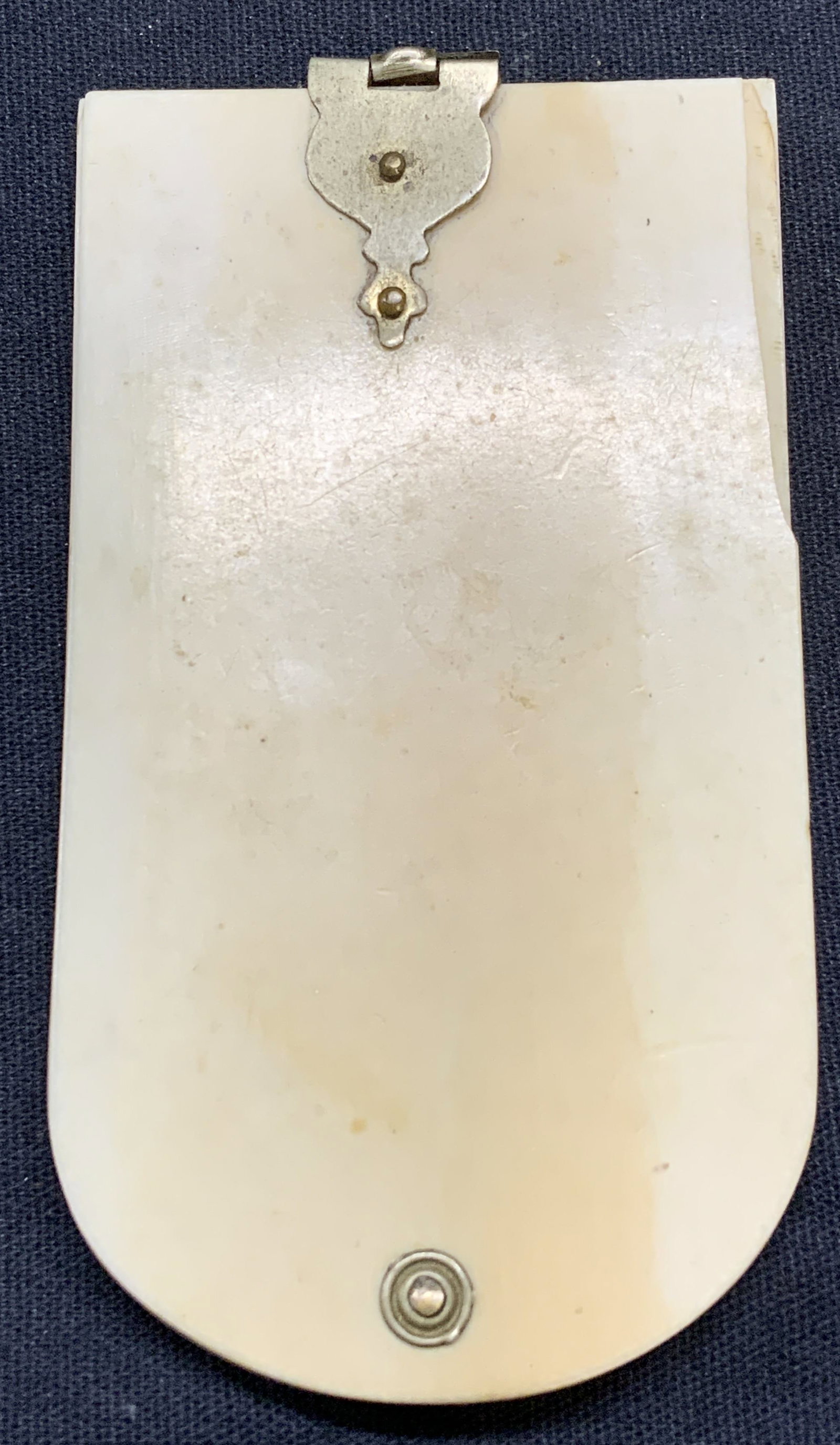 Antique Chatelaine Silver tnd Bone Notepad: Antique Victorian chatelaine bone notepad with. Fanned pages. Silver toned hardware and clasp. Measures approx. 3 3/8 x 1 7/8 inches. Some surface wear including marks and chip observed. Some warping 