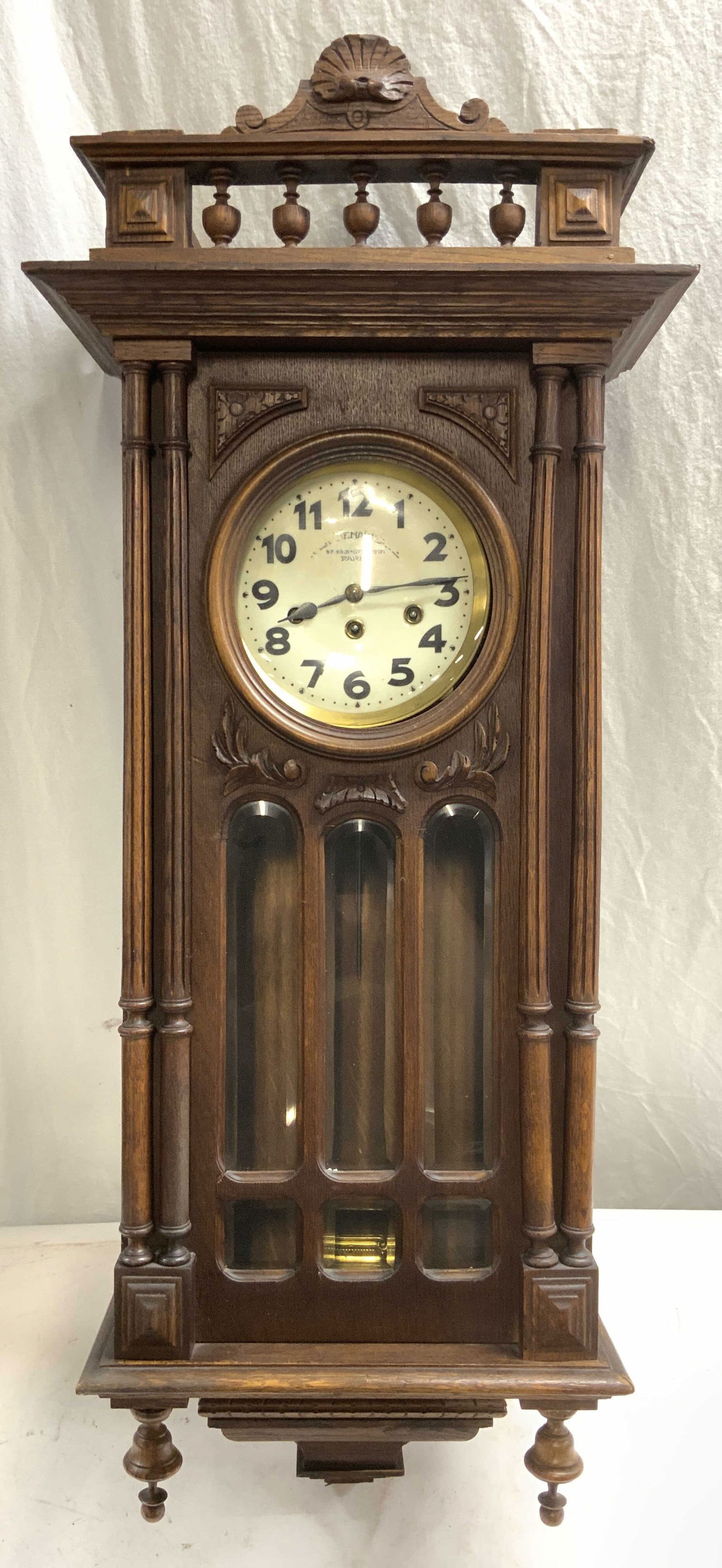 A LA RENAISSANCE Antique Wooden Wall Clock PARIS: Clock face reads A LA RENAISSANCE 47.49B S Martin PARIS. Piece appears to be antique possibly vintage. Clock is brown toned as wooden with intricately carved detail. Clock face is cream with black ton