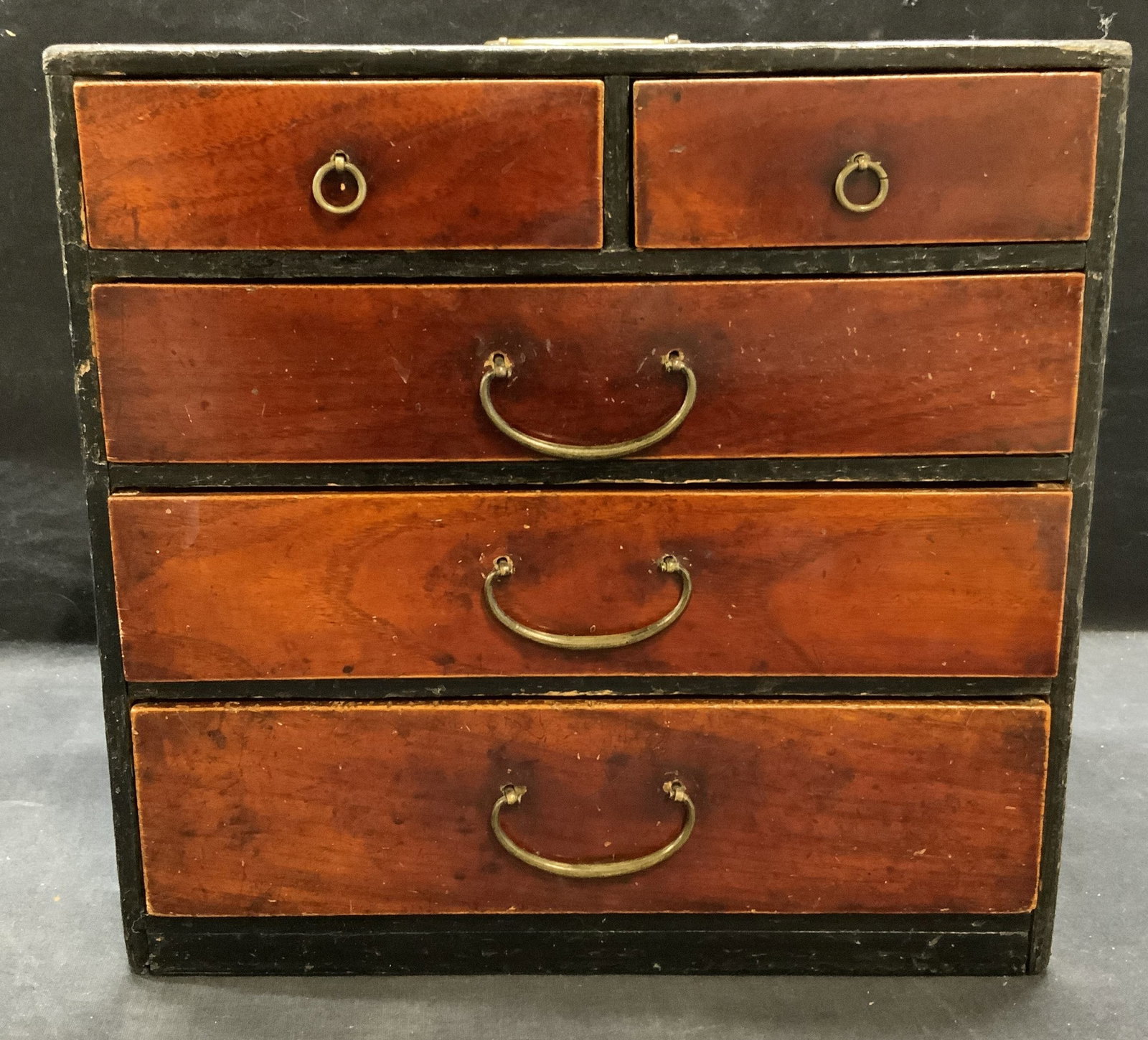 Vintage Signed Japanese Dark Wood Chest 11In: Vintage Japanese dark wood chest/jewelry box with brass handles. Signed to underside. Measures approx. 11 x 6.5 x 11 inches. Possible salesman sample. Surface wear including scratching and warping obs
