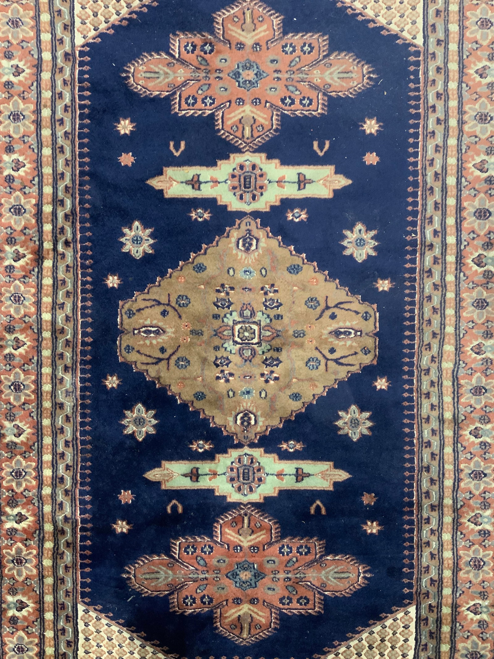 Vintage Handmade Turkish Wool Rug: Rug is handmade and wool. Piece appears to be Turkish. Rug has intricate multi toned floral and geometric detail. Rug has blue toned knotted fringes at edges. Rug measures approximately 81 inches long