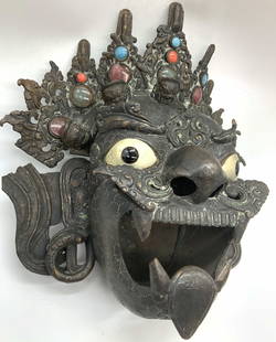 Antique Bronze Tibetan Deity Face Censer: Antique bronze made Tibetan deity face censer, depicting the face with an ornate head piece with imbedded colored glass jewels and silver toned metal eyes. Openings throughout the face and head to all