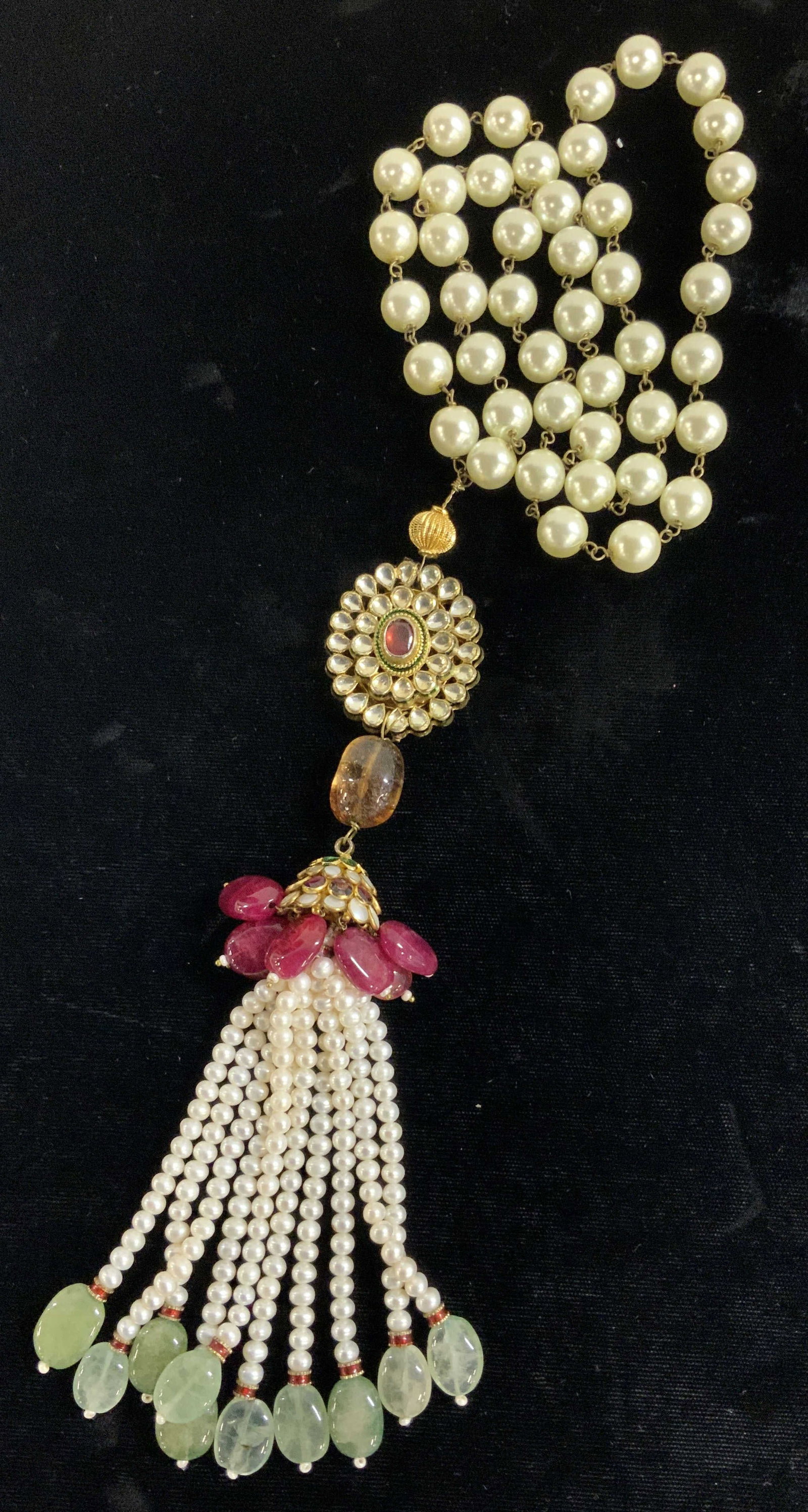 Pearl & Gem Tassel Hollywood Regency Necklace: Luxury hand crafted necklace with a long tassel pendant. Necklace made with glass pearls , 10.5 in. Drop. 7 in. Long pendant consists of a medallion with a center tourmaline stone and clear glass doub