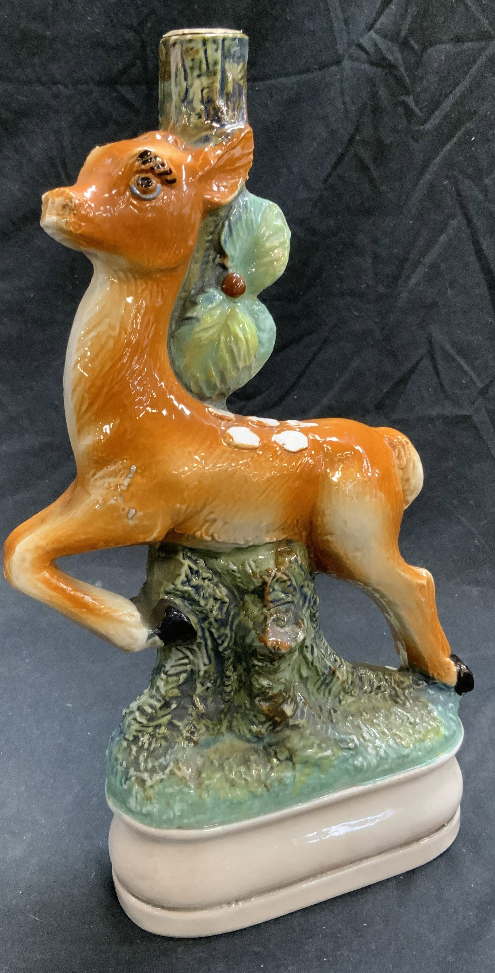 Bischoff Cherry Porc Majolica Liquor Bottle, Italy: Unsealed vintage Cherry liquor porcelain Majolica bottle. Leaping Deer resting on branch Majolica figural. Made in Italy. 1 pint. Bottle measures 11.5 in. Tall, 7 in. Long, 2.75 in. Wide., Label is on