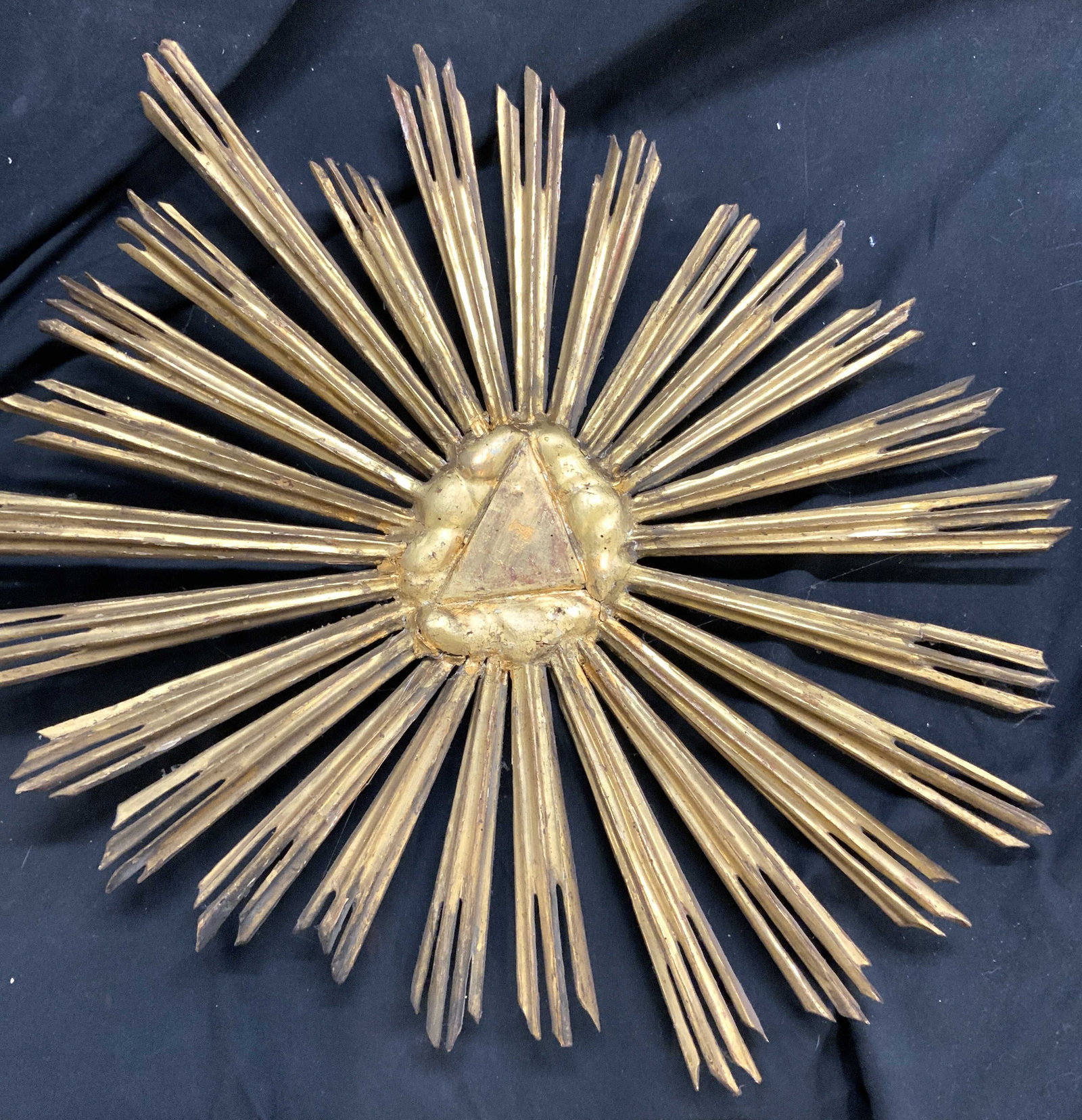 Antique Gilt Wood Sunburst Sculpture Europe 26.5in: 21.5 x 26.5 in. antique gilt wood sunburst wall decor. Possibly 19 th century or Early 20th century European. Hand carved wood and hand crafted. Delicate, has been repaired with glue., some loss of gi