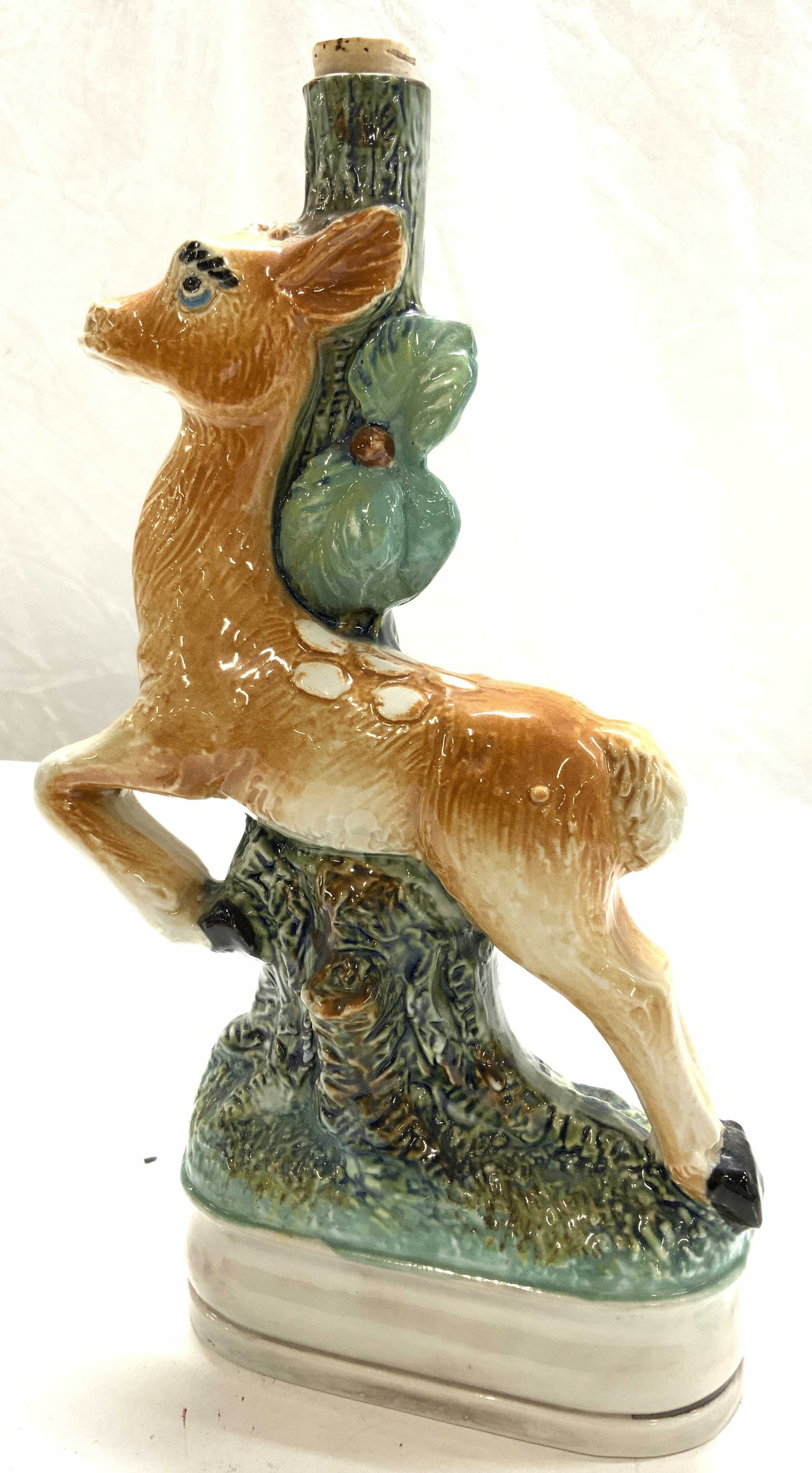 Bischoff Cherry Porc Majolica Liquor Bottle, Italy: vintage Cherry liquor porcelain Majolica bottle/ decanter. Deer and branch Majolica figural. Made in Italy. Opened bottle with some liquor in bottle.. Bottle measures 11.5 in. Tall, 7 in. Long, 2.75 i