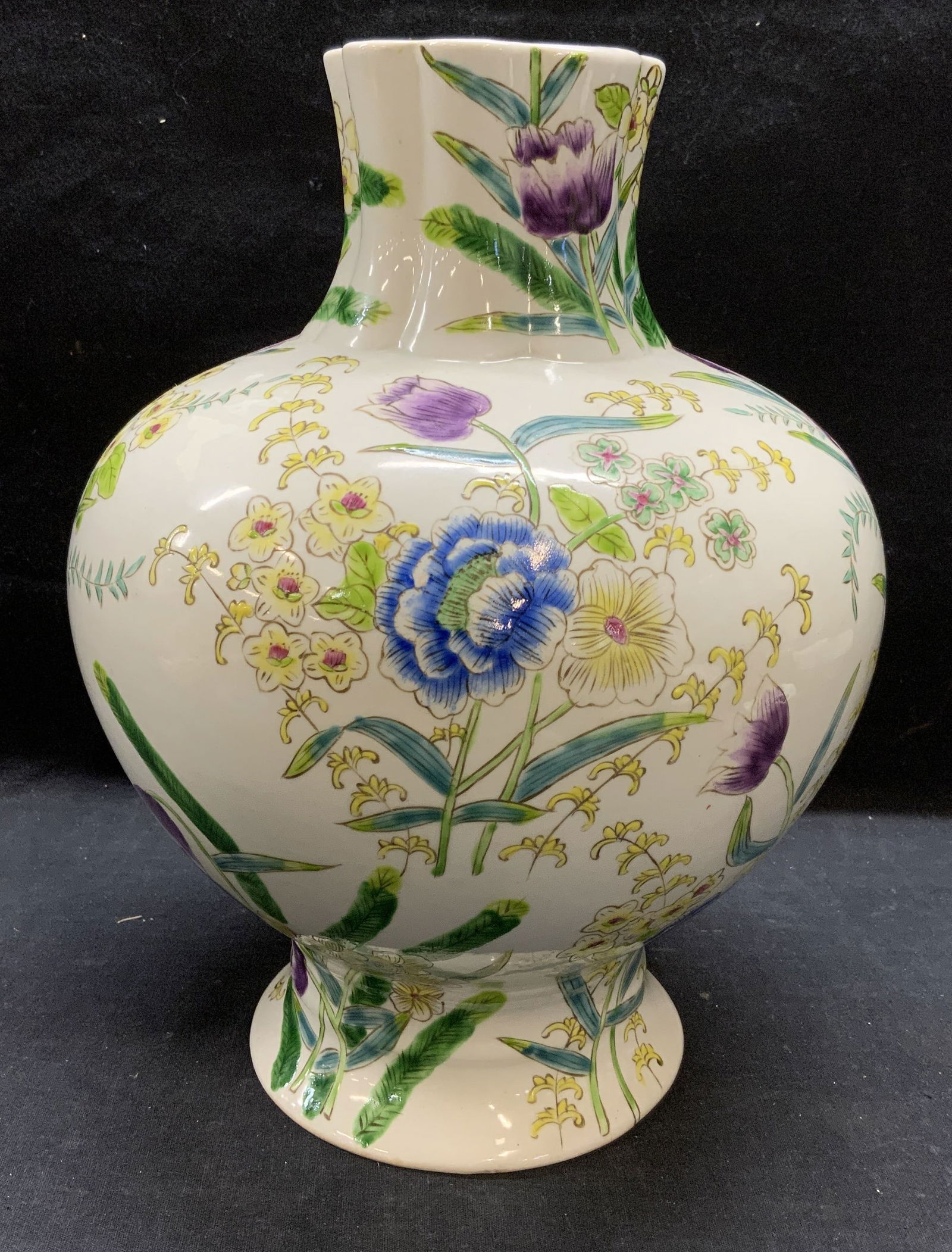 Vintage Chinese Porcelain Floral Vase: Vintage, possibly antiques, Chinese porcelain vase with hand painted floral motif in hues of green, purple, and yellow. Stamp to underside not visible, hole drilled to underside. Measures approx. 8.5