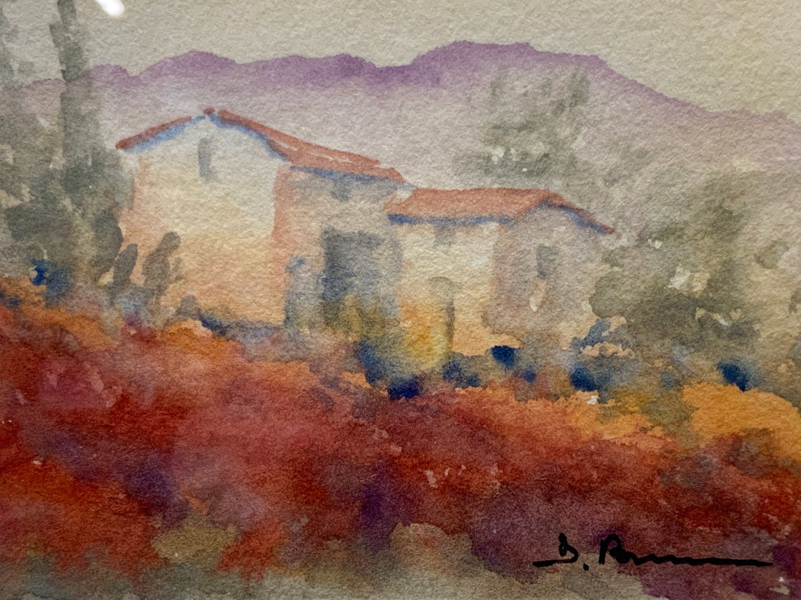 Signed Watercolor Landscape Painting: Signed on lower right corner in ink. Depicts a landscape watercolor with red roofed houses. Framed in a silver leafed wooden frame with off white mat board, approx 9.5 x 11 inches window measures 4 x 