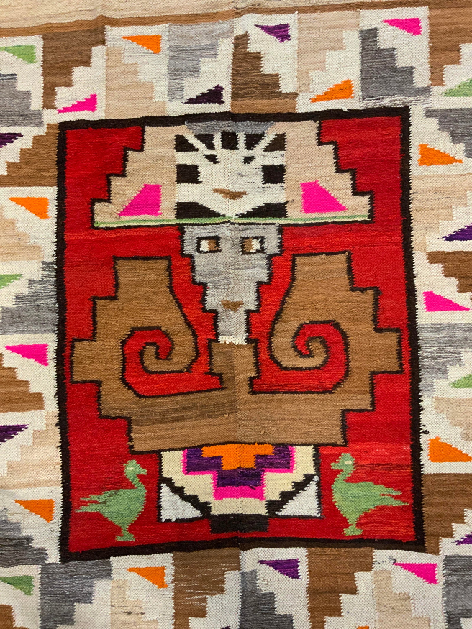 Vintage Handwoven Wool Area Rug: Rug is handmade and appears to be wool, possibly yarn. Piece has intricate multi toned geometric detail with tribal stylings, duck and facial detail. Rug Measures approx 71 Inches long 50 inches wide.