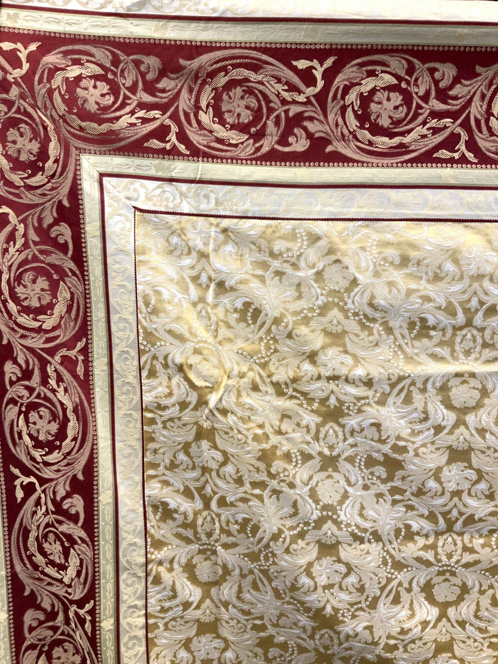 Waterford Cotton French Scroll Tablecloth 82in: Marked on tag Waterford, cotton and polyester, adorn in French style scrolls with red and gold toned threading with white highlighting. Approx 82 x 62 inches Moderate wearing to threading due previous