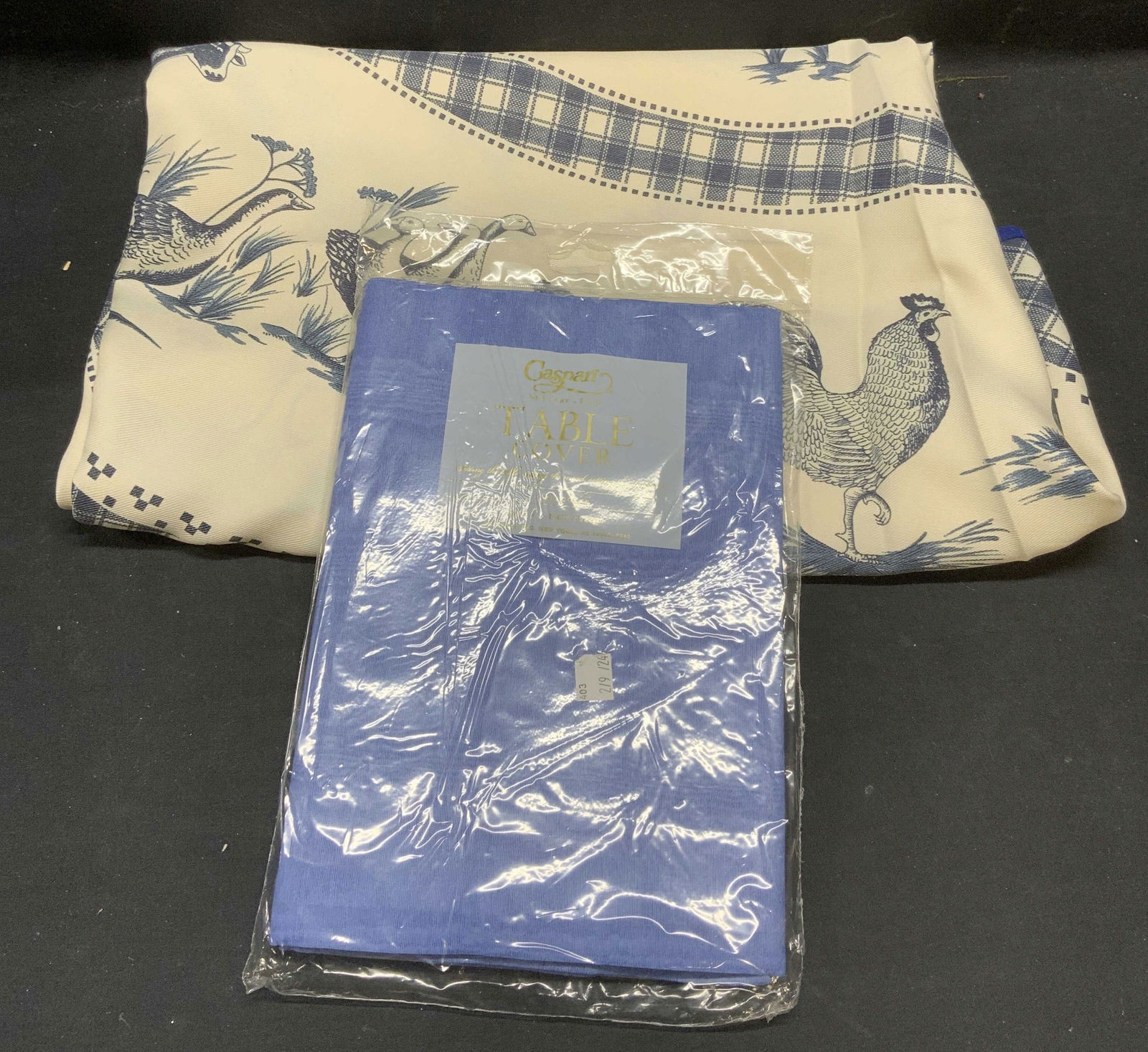 Lot 2 Caspari Table Cover NIP, More: Lot of 2 pieces. Caspari lavender blue table cover. Material unknown. Measures 4.5 x 7 feet. New in unopened package. White and blue graphic print tablecloth with farm animal motif. Measures approx. 7