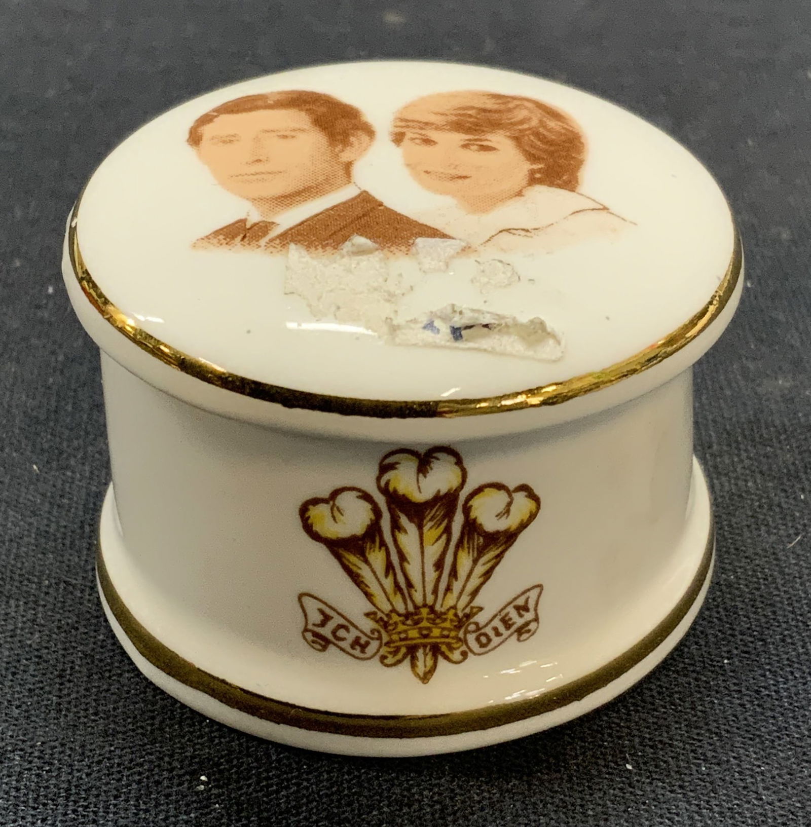 Vintage Queensway Charles & Diana Pill Box: Vintage Queensway fine bone china pill box with Prince Charles and Princess Diana motif. Trademarked to underside. Measures approx. 1.75 x 1 inches. Some surface wear including scratching observed. Ch