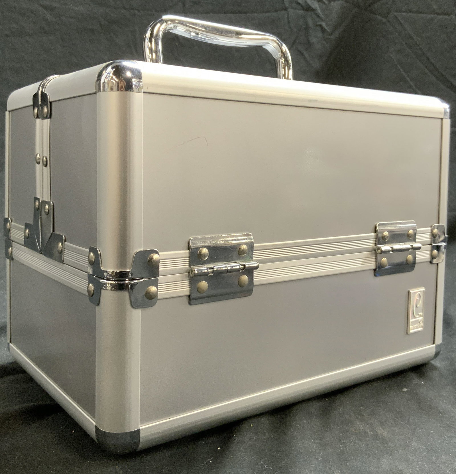 CTM CABOODLES Transforming Jewelry Box W Handle: Trademark reads CTM CABOODLES. Jewelry box is silver toned appears to be metal. Interior is black with patterned detail. Lid splits in center to reveal 2 compartments per side. When closed box measure