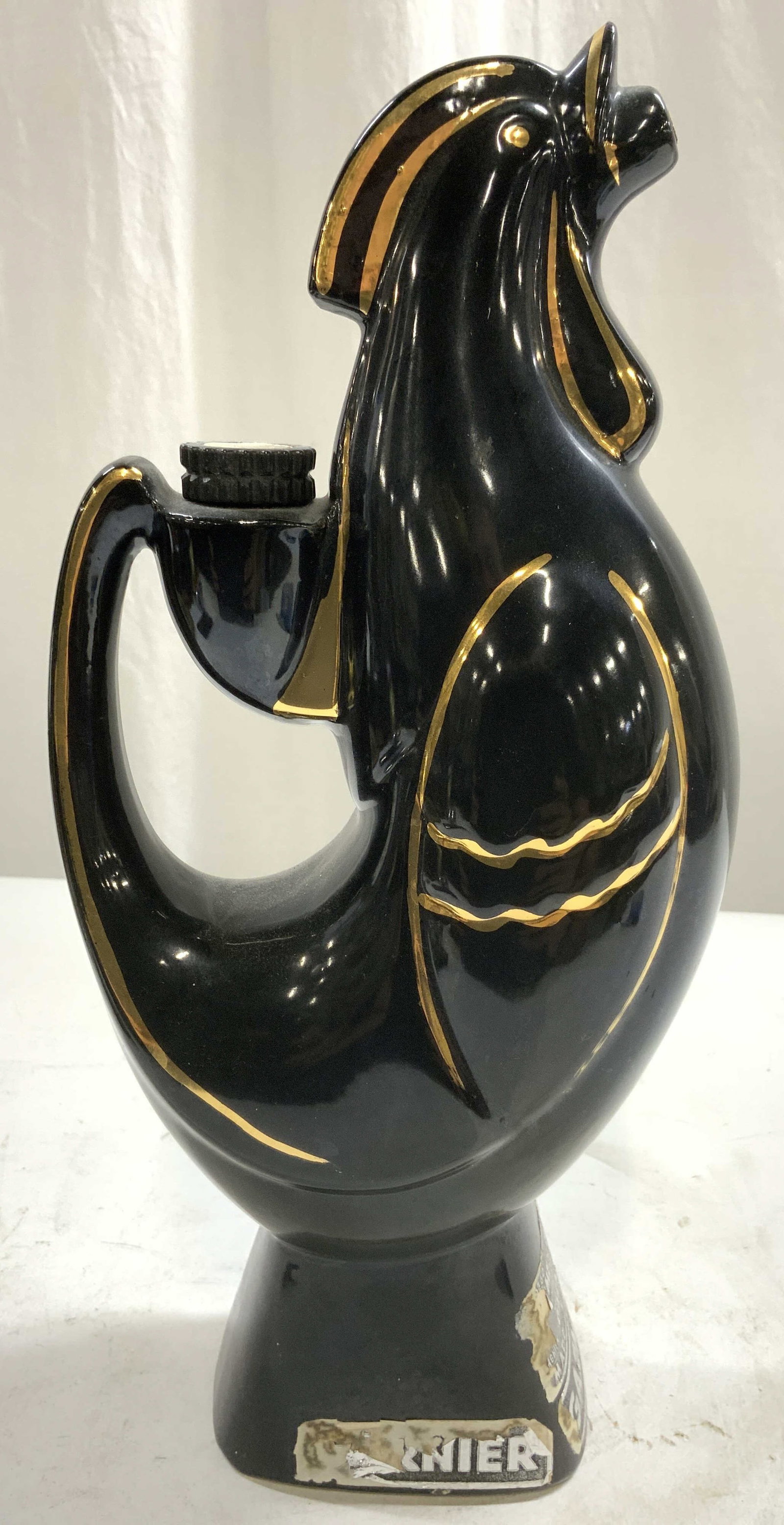 GARNIER Vtg Porc Rooster Liquor Bottle FRANCE: Tag reads GARNIER. Piece is black with gilt piping detail. Bottle has rooster form. Piece is vintage. Includes cap. Measures approximately 12 inches tall 5.5 inches deep 3.25 inches wide. Bottle, liqu