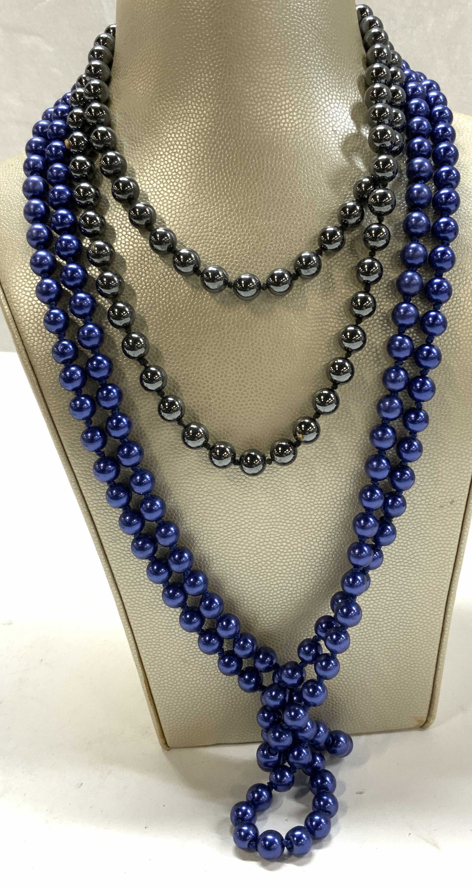 2 Pearl Style Necklaces , Glass & Gunmetal Beads: Beaded necklaces, both double knotted. One is a gunmetal bead necklace with a 15 in. Drop. Other is a metallic blue rope length glass beaded necklace , 28 in. Drop., both have weight. Blue glass pearl