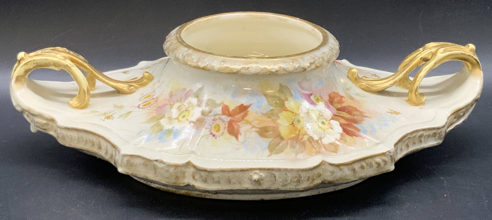 ROYAL BONN Germany Vintage Porcelain Vessel: A vintage hand painted floral motif vessel with raised gilt porcelain handles. Raised porcelain details throughout. Underside stamped ROYAL BONN GERMANY. In blue to underside it reads 41201 DEC 33406 