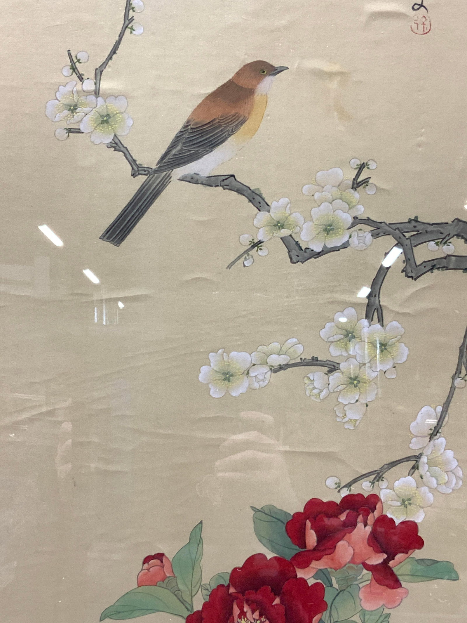 Stamped Asian Bird Silk Painting: Stamped on upper right corner with calligraphy Depicts a bird perched on a branch with red flowers. Framed in a dark wooden frame with bamboo notches. Approx 44 x 18 inches window measures 37 x 12 inc