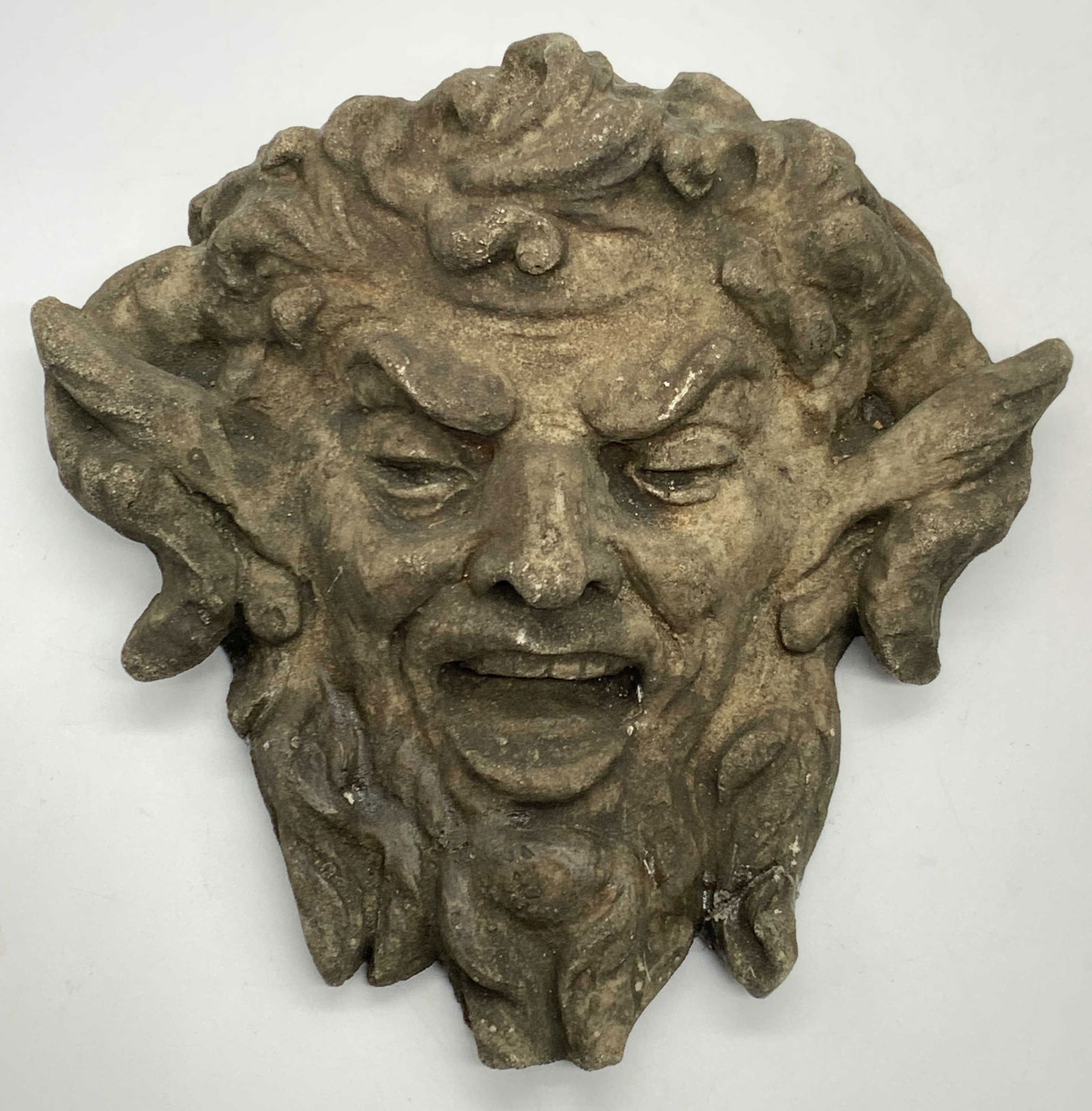 1984 Pan Plaster Mask Wall Plaque New Orleans: Marked on accident New Orleans 1984. A plaster made pan mask wall plaque with pointed ears beard and curly hair. Approx 6.5 inches tall and 6 inches wide. Moderate wearing to exterior coating to plast