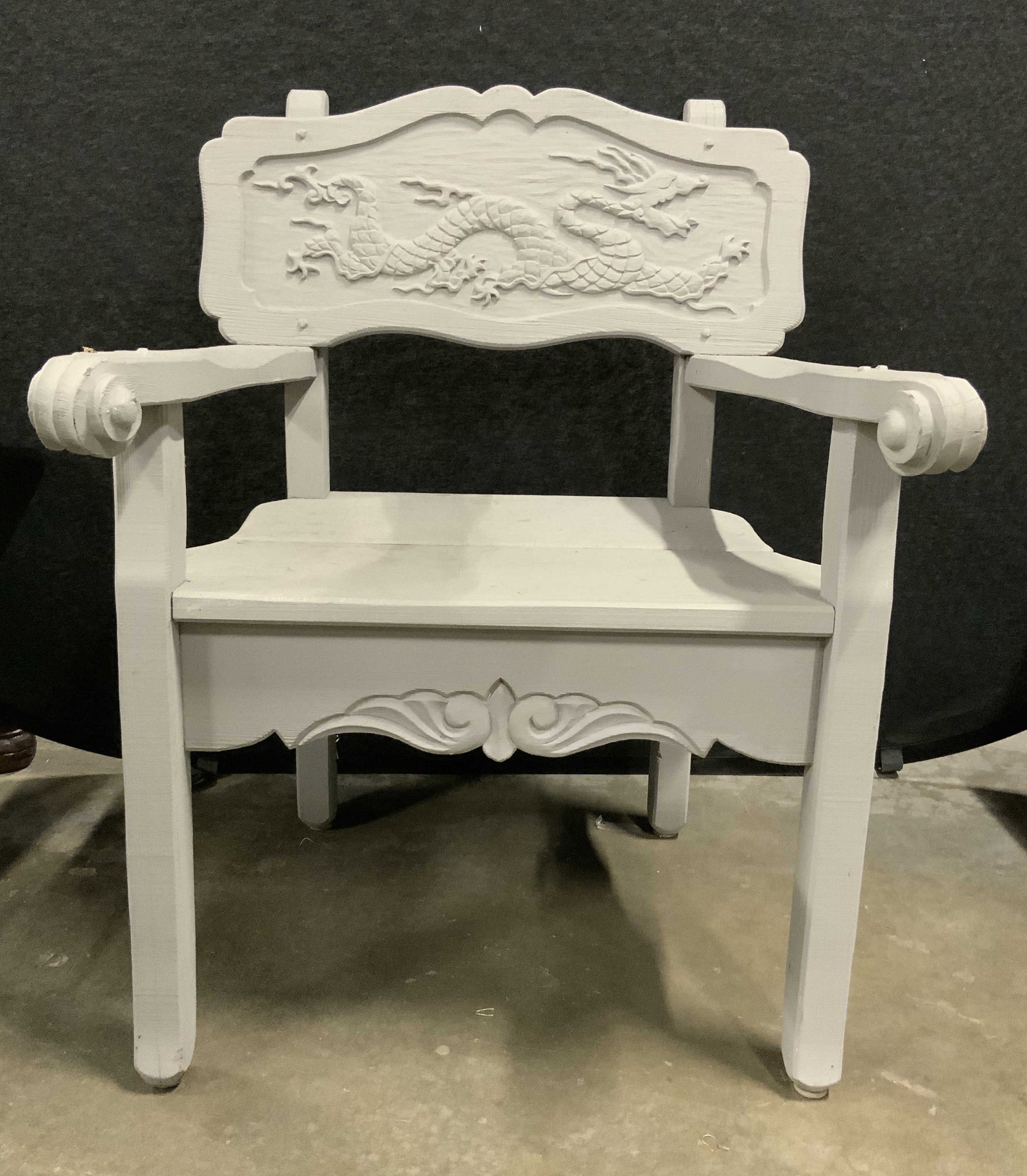 Vintage Asian Carved Wooden End Chair Slate: End chair is vintage. Piece is wooden with carved dragon detail on backrest & carved wooden arms with curls at ends. Piece has light slate tone. Measures approximately 36 inches tall, 27 Inches wide &