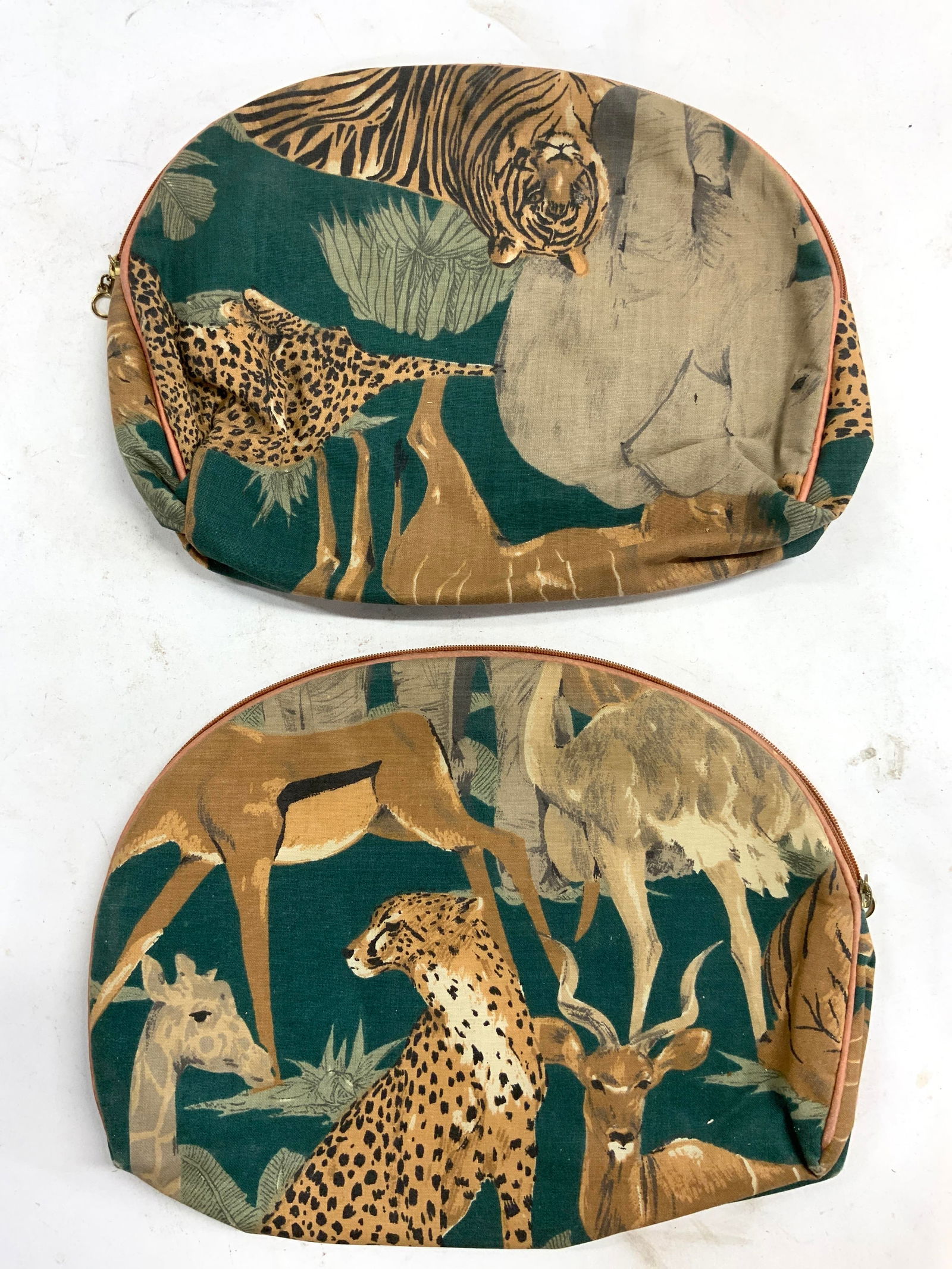 Lot 2 Zippered Cosmetic Bags W Animal Detail: Lot includes 2 cosmetic bags. Each have detail depicting various animals. Each bag has zippered opening. Bags each measure approximately 10.5 inches wide 8 inches tall. Pouches, cosmetic bags, zippere