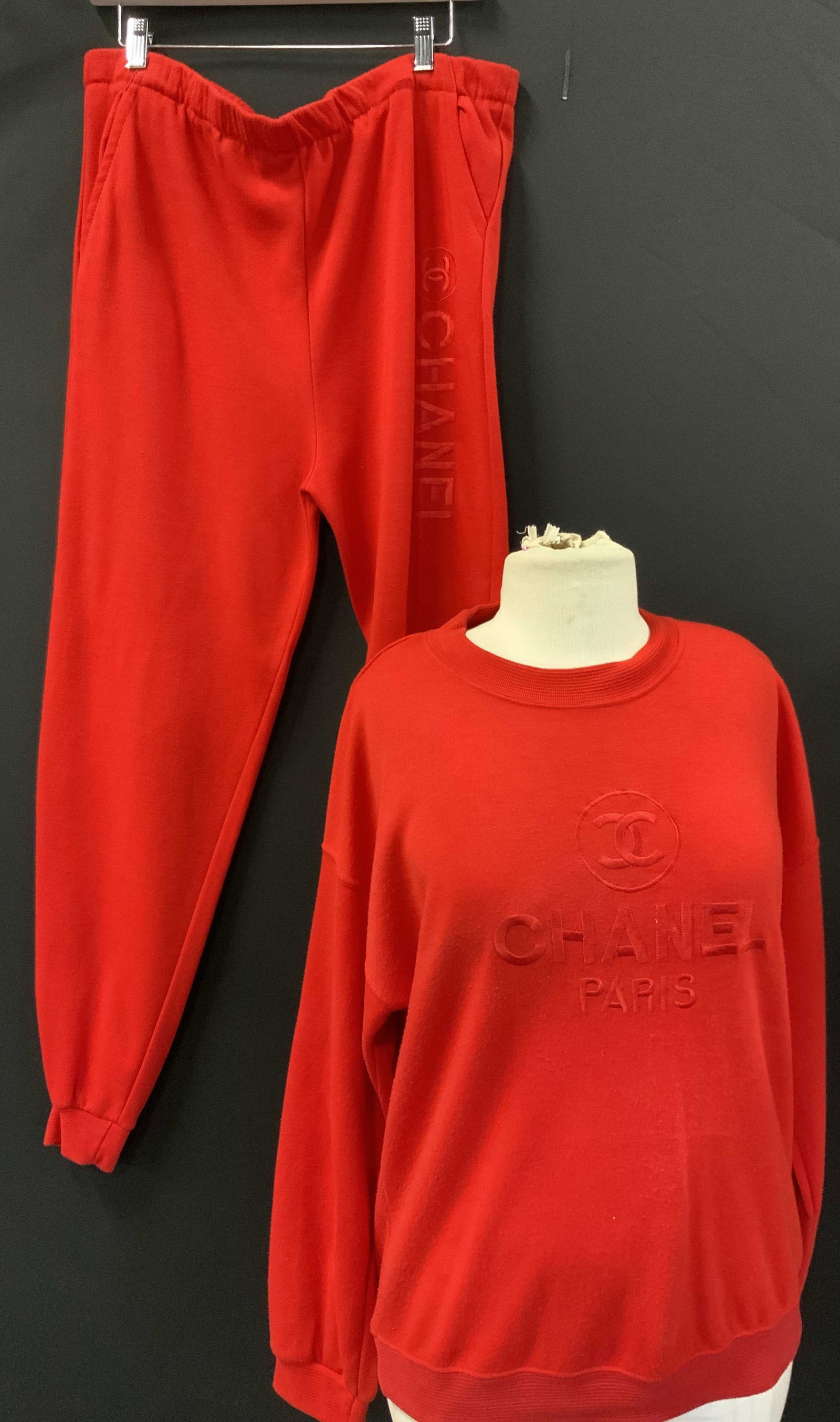 Chanel Style Cotton Sweatshirt & Joggers, 2: Chanel cotton clothing in red. Sweatshirt and joggers. Some wear to clothing. Sweatshirt has Chanel Label , size Med. Jogger pants have pockets. Inseam is 27.5 in. Stretch waist is stretched and worn.