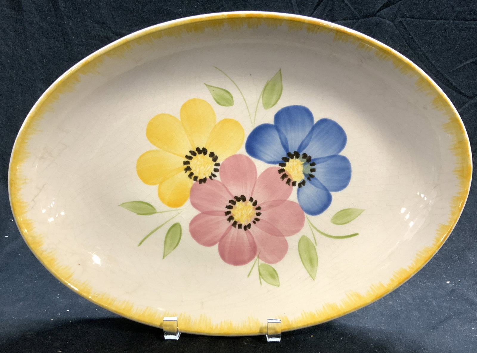 San Giovanni Valdarno Painted Ironstone Platter: Made in Italy is this vintage Ironstone hand painted platter. Dishwasher proof. Large flower decor in colors of pink, blue, and yellow with yellow rim. Stamped San Giovanni Valdarno industrial Ceramic