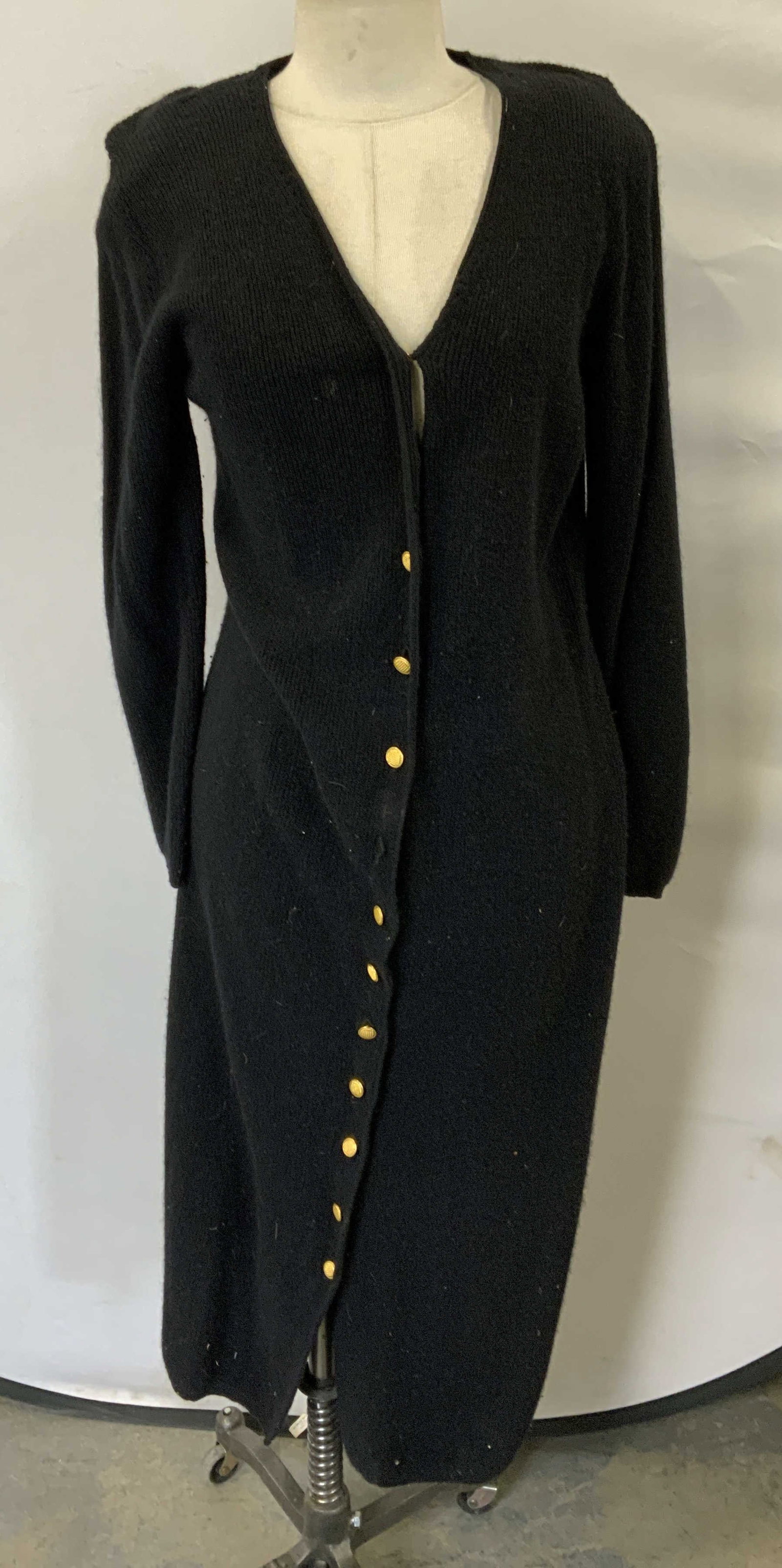 Outlander Black Wool Angora Long Cardigan: Outlander black long cardigan sweater. Size M. Wool, angora and nylon blend. Wear to material including blemishes and small tear observed. Some buttons need replacement. Outlander, a outlander sweater