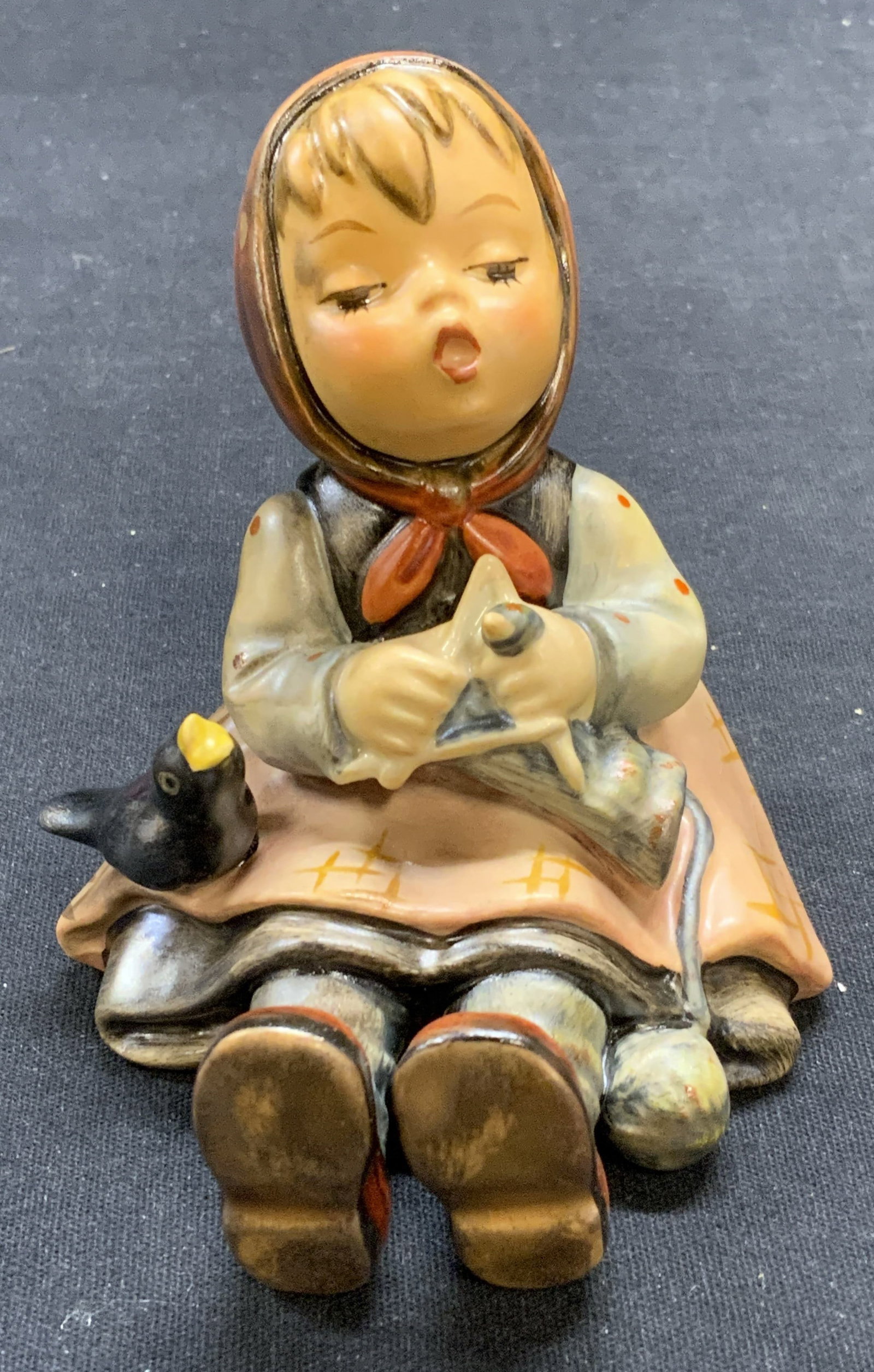 Vintage GOEBEL Hummel Porcelain Figural Germany: Vintage GOEBEL MJ Hummel porcelain figurine. Girl and bird. Trademarked to underside. Made in Germany. Measures approx. 3 x 3.25 x 4 inches. Includes Macys box. Some scratching observed. GOEBEL, GOEBE