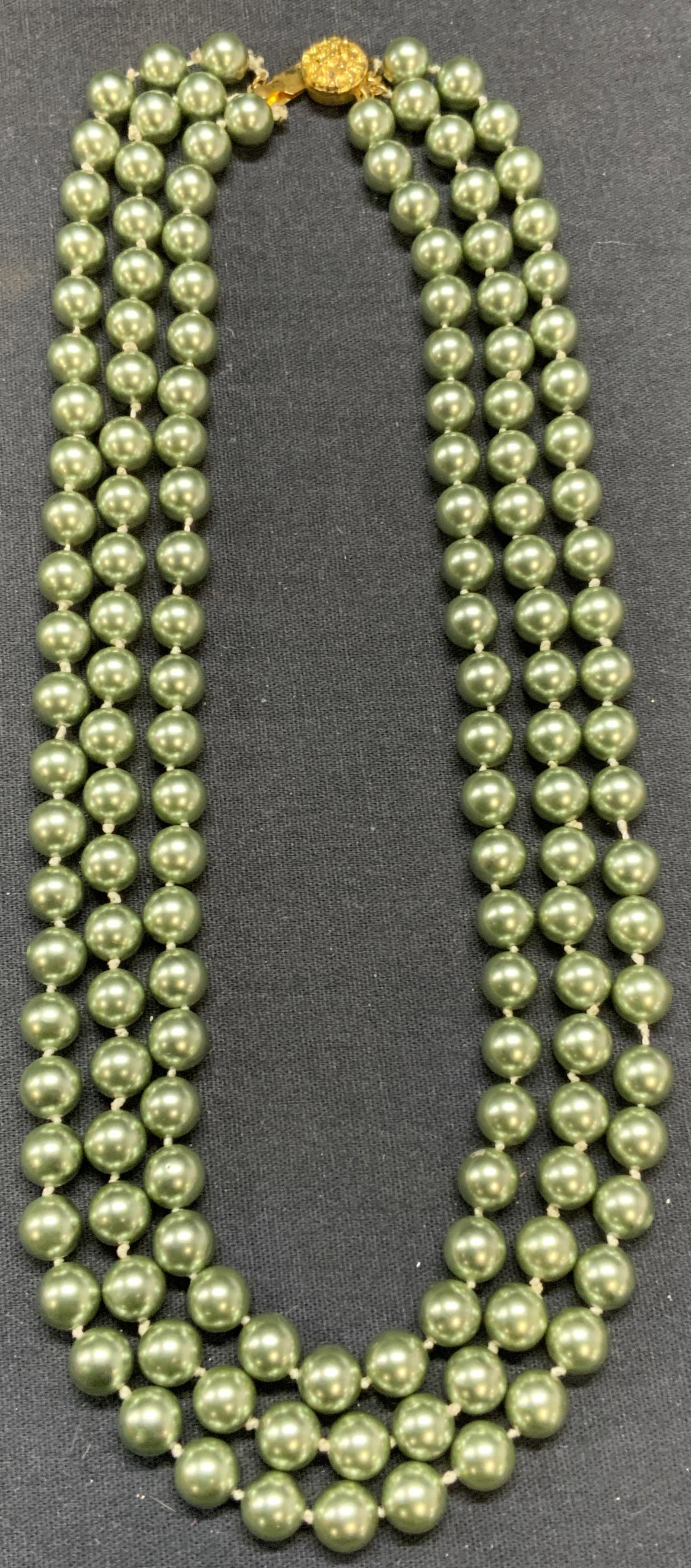 Green Faux Pearl 3 Strand Necklace: Green faux pearl beaded 3 strand necklace on double knotted string. Drop length approx. 8 inches. Piece has weight. Some scratching observed. Estate jewelry, costume jewelry, cocktail jewelry, fashion