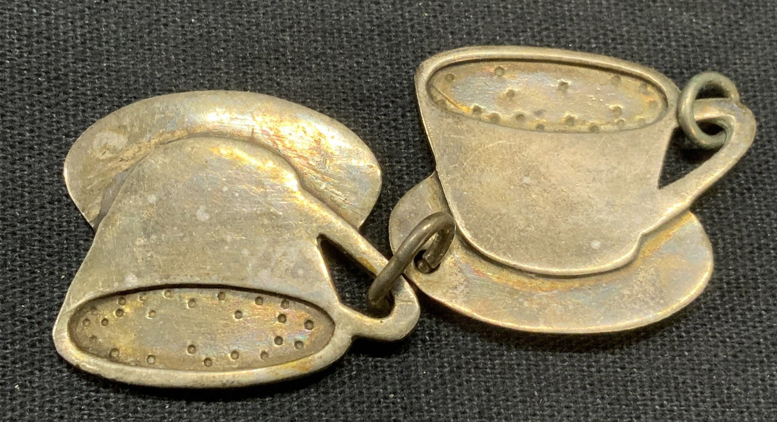 Lot 2 Signed Sterling Silver Coffee Cup Charms: Lot of 2 sterling silver silver coffee cup charms. Hallmarked and marked Design to undersides. Test for sterling using PuriTEST kit. Total weight .25 ozt. Measure approx. 1 x 1 inches each. Some surfa